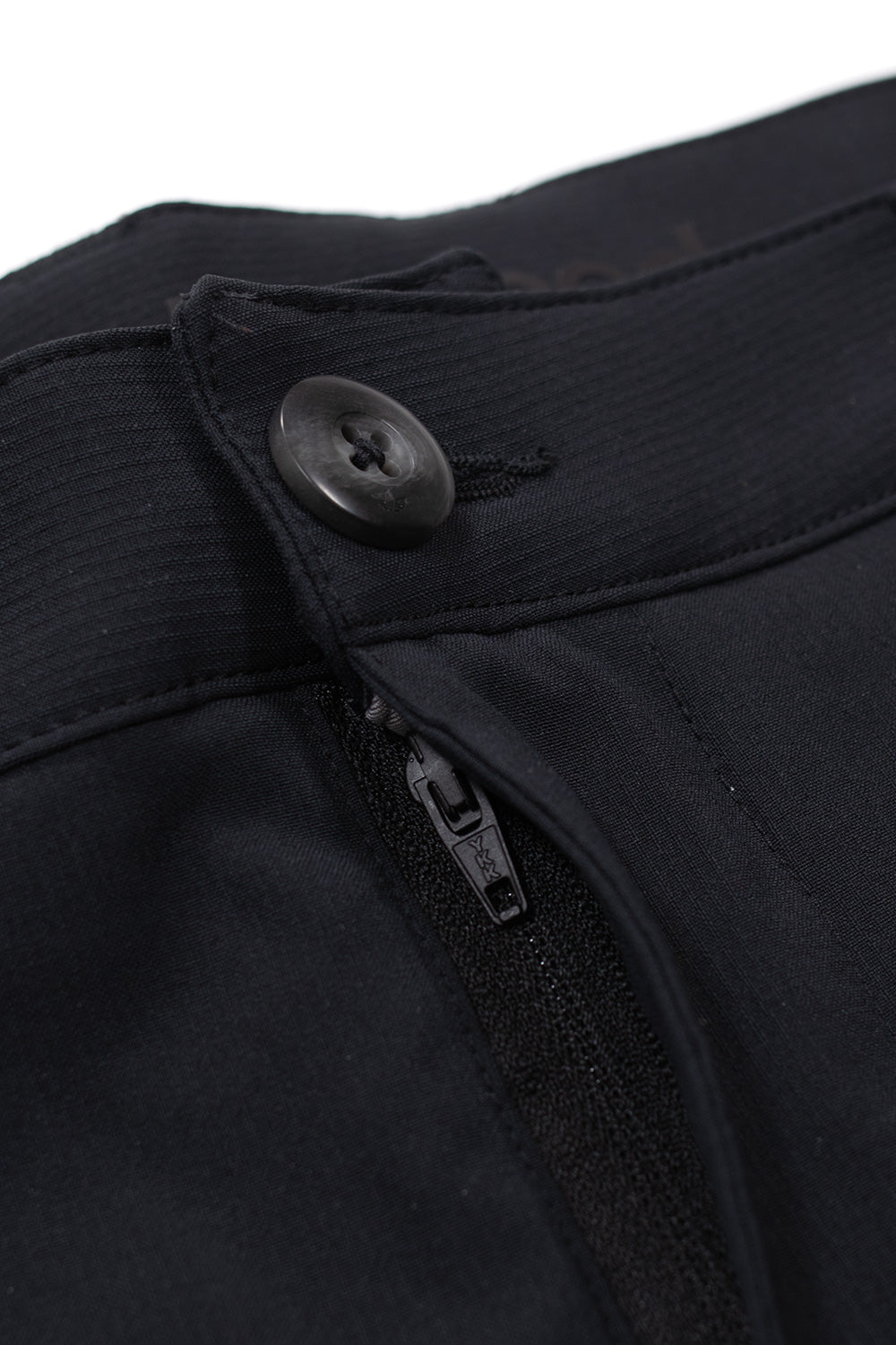 Close-up of Adidas Metalwood tracksuit bottoms waistband showing button fastening and zip fly, premium stretch woven fabric construction, technical golf pants detail shot