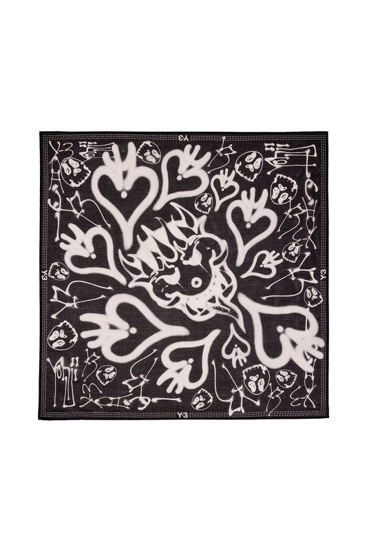 Full flat lay top view of the black and white Adidas Y-3 X Chito Bandana, crafted from a premium silk-cotton blend measuring 59 cm by 59 cm, featuring an intricate collage of white airbrushed hearts, dripping skulls, a central monster face, and decorative stitched contrast borders with Y-3 logos.