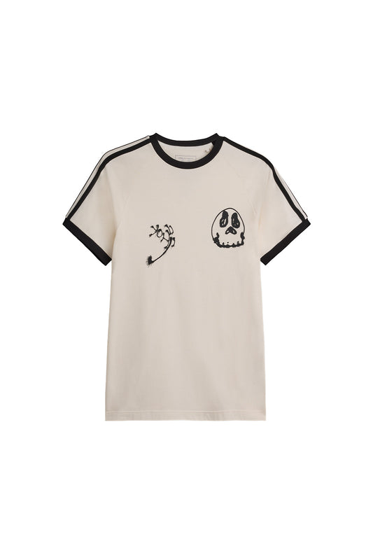 Front view of the off-white Adidas Y-3 X Chito Graphic Cali Tee, crafted from premium cotton jersey with black ribbed ringer collar and cuffs, sewn-on black 3-Stripes along raglan shoulders, and black airbrushed Yohji calligraphy alongside a surreal skull motif printed on the chest.