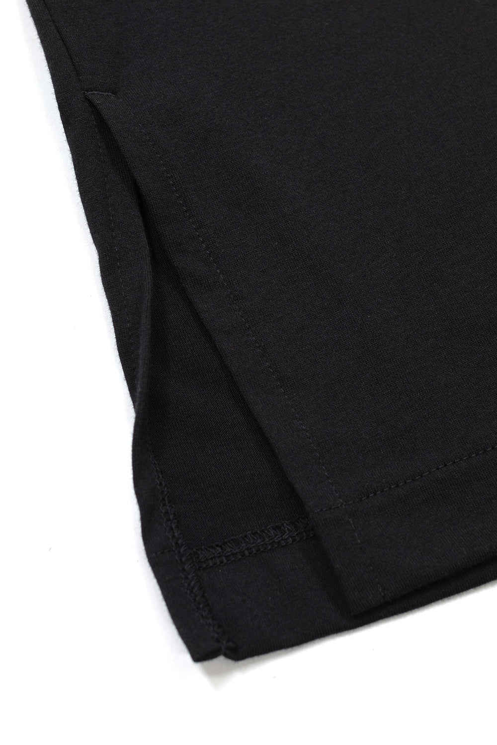 Detail view of the lower hem on the black Adidas Y-3 X Chito long sleeve shirt, displaying the split side vent hem with clean reinforced interior stitching.