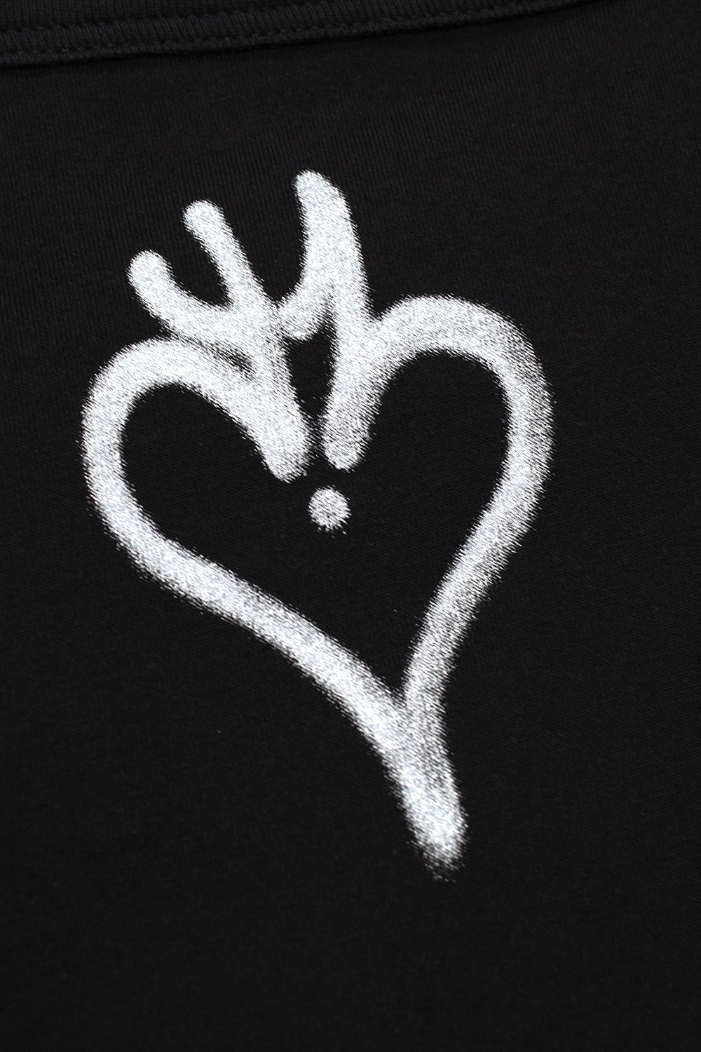 Close-up view of the back collar on the black Adidas Y-3 X Chito Skull Graphic T-Shirt, highlighting the white airbrushed stencil heart emblem printed below the ribbed neckline seam.