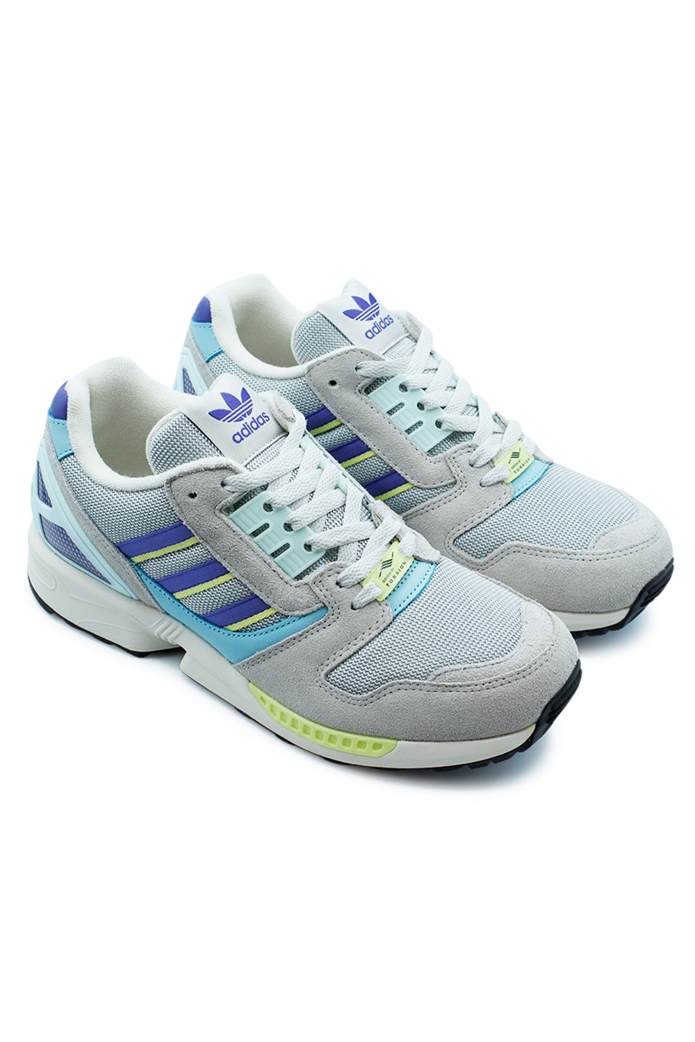 Studio shot of a pair of adidas ZX 8000 Grey Two and Purple sneakers placed together at an angle, displaying the retro multi-textured upper design.