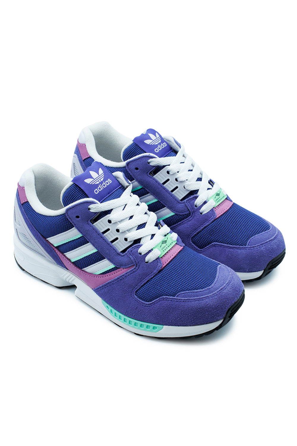 Studio shot of a pair of adidas ZX 8000 Purple and Frozen Purple sneakers placed together at an angle, displaying the complex multi-textured upper design.