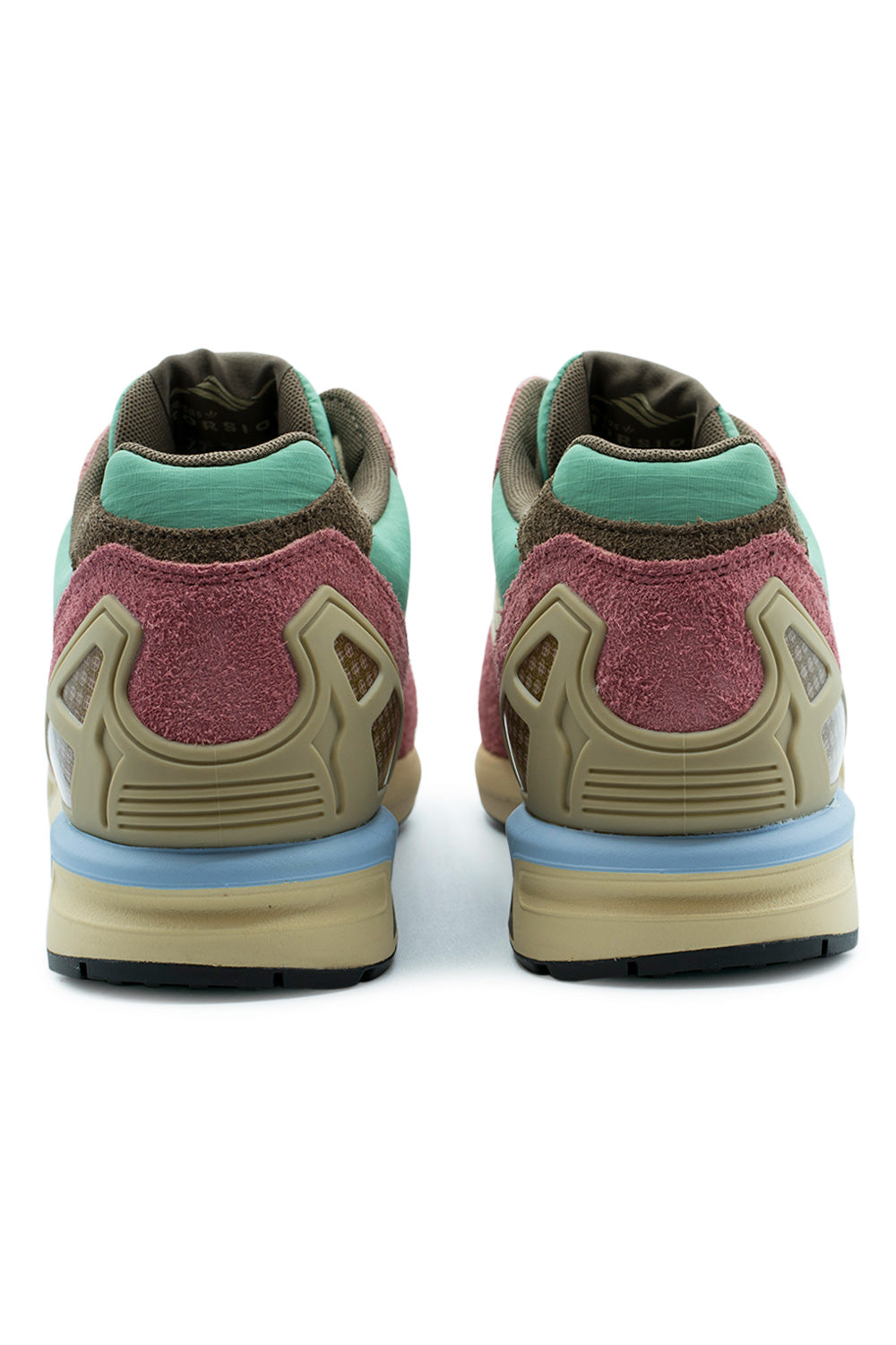 Rear perspective shot of the heels on the Adidas ZX 8000 sneakers, showing the semi-translucent olive-tan TPU heel counter cages, dusty rose hairy suede upper heel overlays, soft mint green ripstop collars, baby blue midsole wedge accents, and brown textile lining