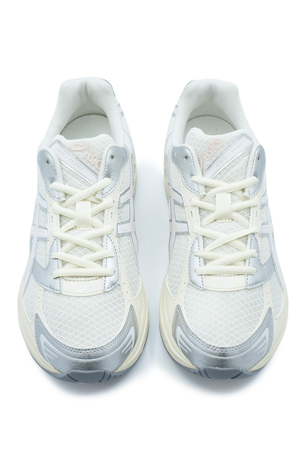 Top-down studio shot of a pair of Asics Gel-1130 sneakers, highlighting the breathable cream mesh toe boxes, metallic silver toe cap reinforcement panels, flat cream laces laced through synthetic eyelet stays, and padded mesh tongues with embossed "GEL-1130" and Asics branding.
