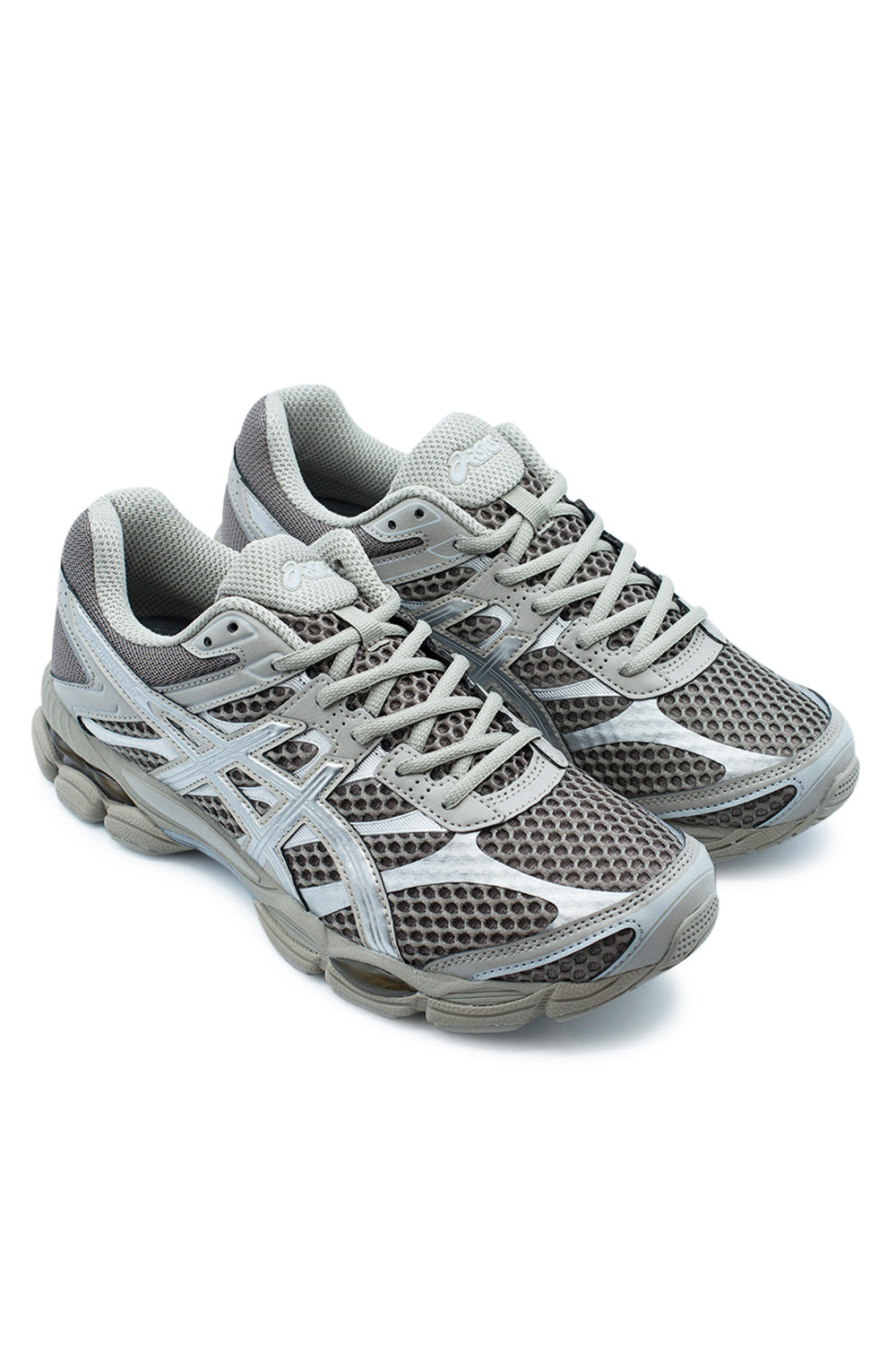 Elevated three-quarter studio perspective of the Asics Gel-Cumulus 16 in Cocoa Powder / Pure Silver, emphasizing the intricate 2014 technical running silhouette, multi-layer metallic framing over open mesh, and sculpted high-mileage cushioning unit.