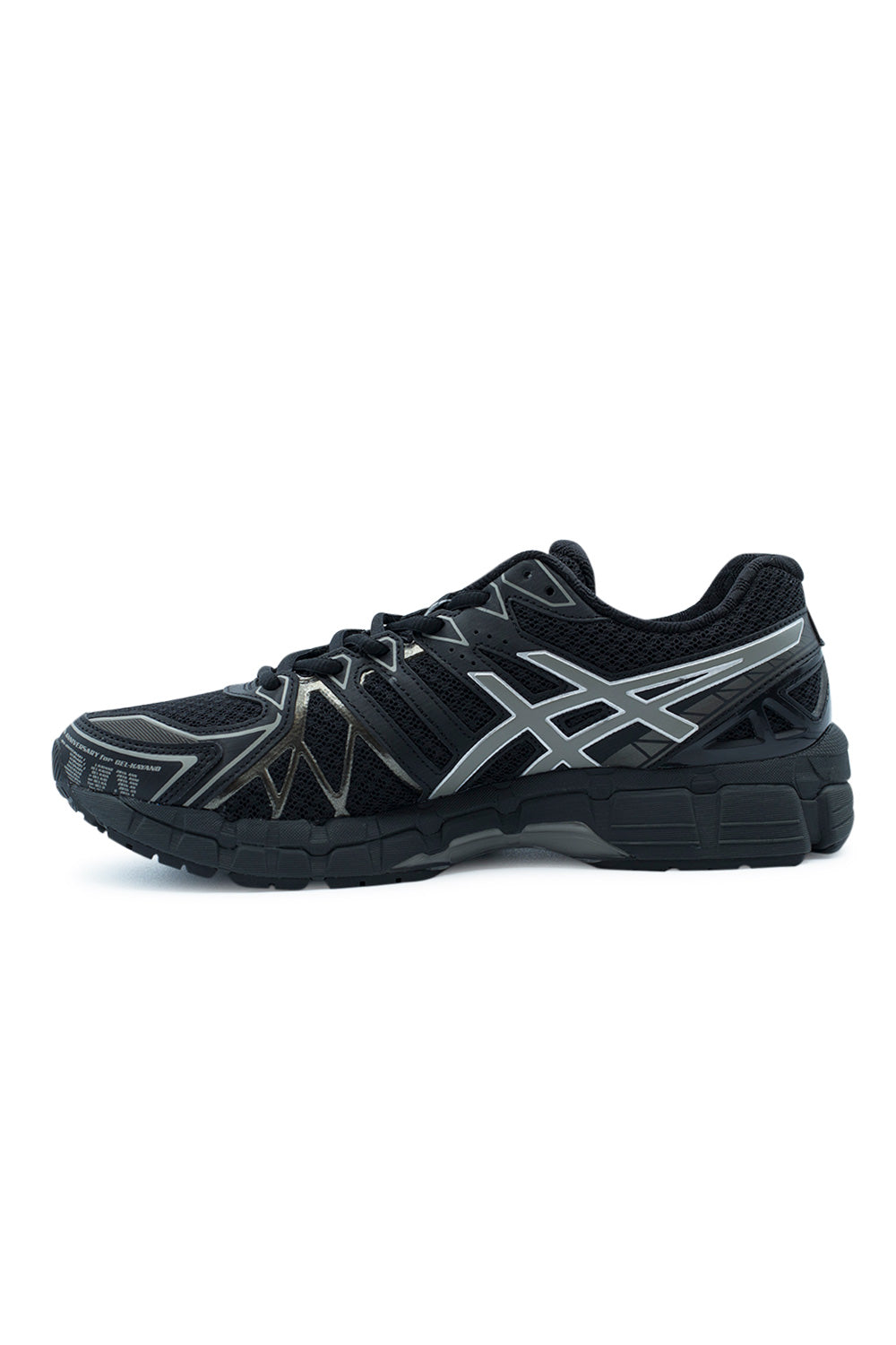 Medial arch profile view of the Asics Gel-Kayano 20 sneaker, detailing the inner side FLUIDFIT lockdown cage over dark mesh, subtle clay grey and silver accents along the tiger stripes, and the segmented supportive black midsole with integrated stability chassis.