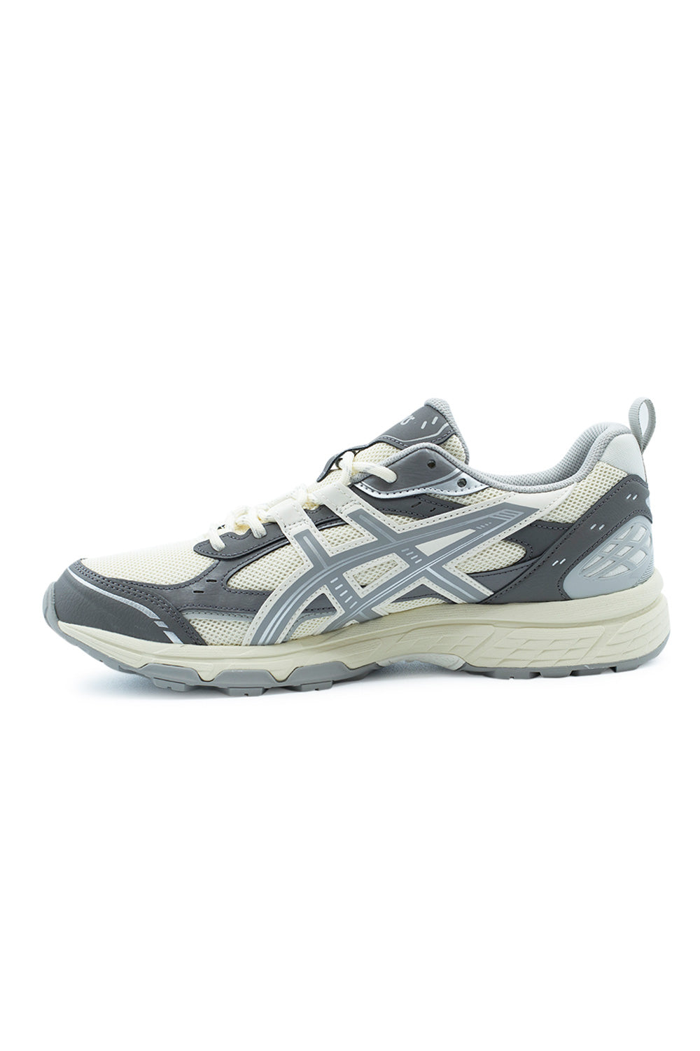Medial arch profile of the Asics Gel-Nunobiki running sneaker, highlighting the breathable cream honeycomb mesh, dark cement grey structural overlays, sculpted EVA foam midsole with rearfoot GEL cushioning, and durable tread outline.