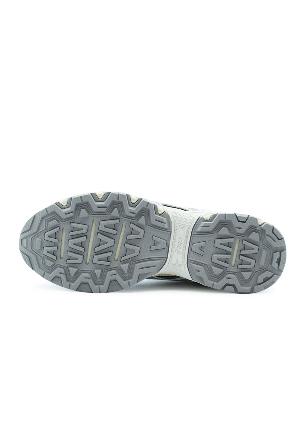 Full bottom perspective of the Asics Gel-Nunobiki trail outsole, displaying the multidirectional chevron grip lugs in cement grey rubber and the molded cream midfoot stability bridge featuring embossed Asics branding.