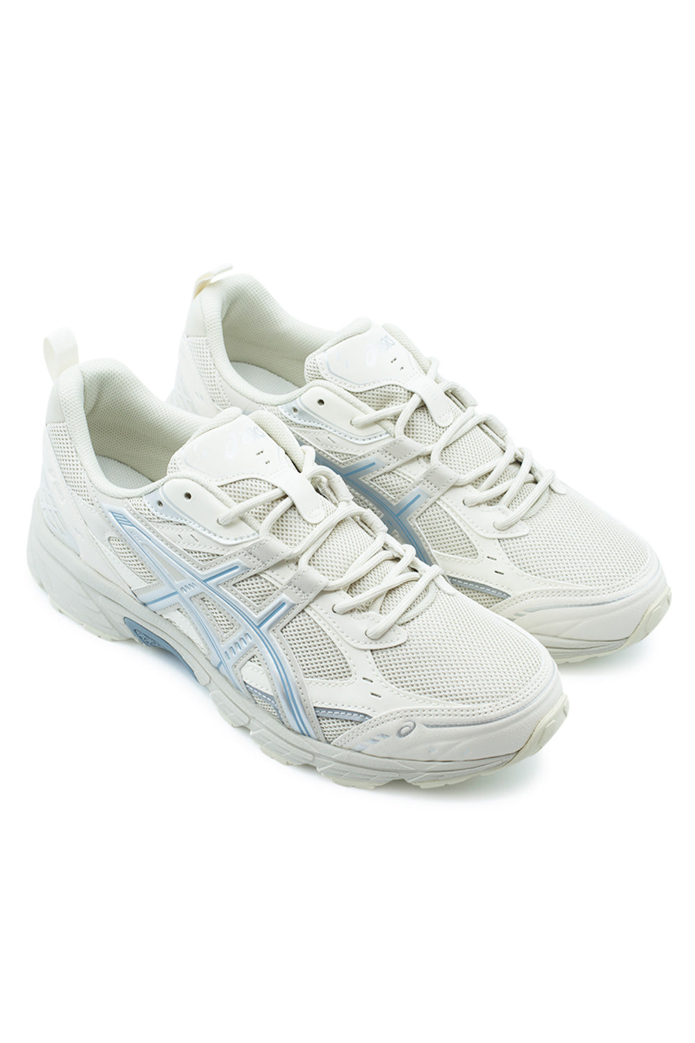 Elevated three-quarter studio view of the Asics Gel-Nunobiki in Smoke Grey and Slate Blue, showcasing the hybrid aesthetic cues from the archival Gel-Kahana 3 and Gel-Target, featuring layered cream paneling and outdoor-inspired utilitarian detailing.