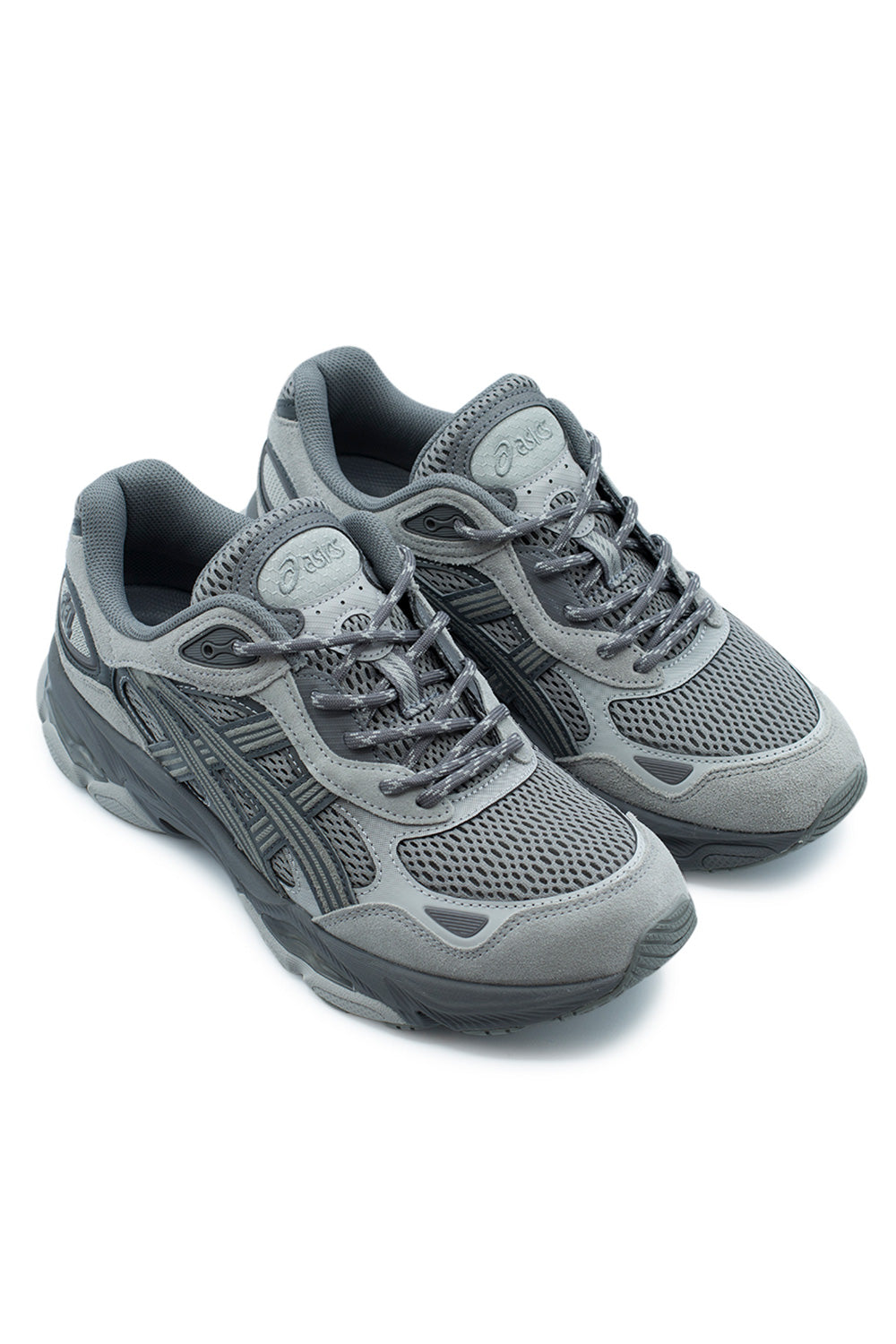 Elevated three-quarter studio perspective of the Asics Gel-NYC 2.0 in Clay Grey / Cement Grey, capturing the dynamic Y2K performance running lines, multi-layered mesh and suede upper construction, and chunky modern lifestyle sole silhouette.