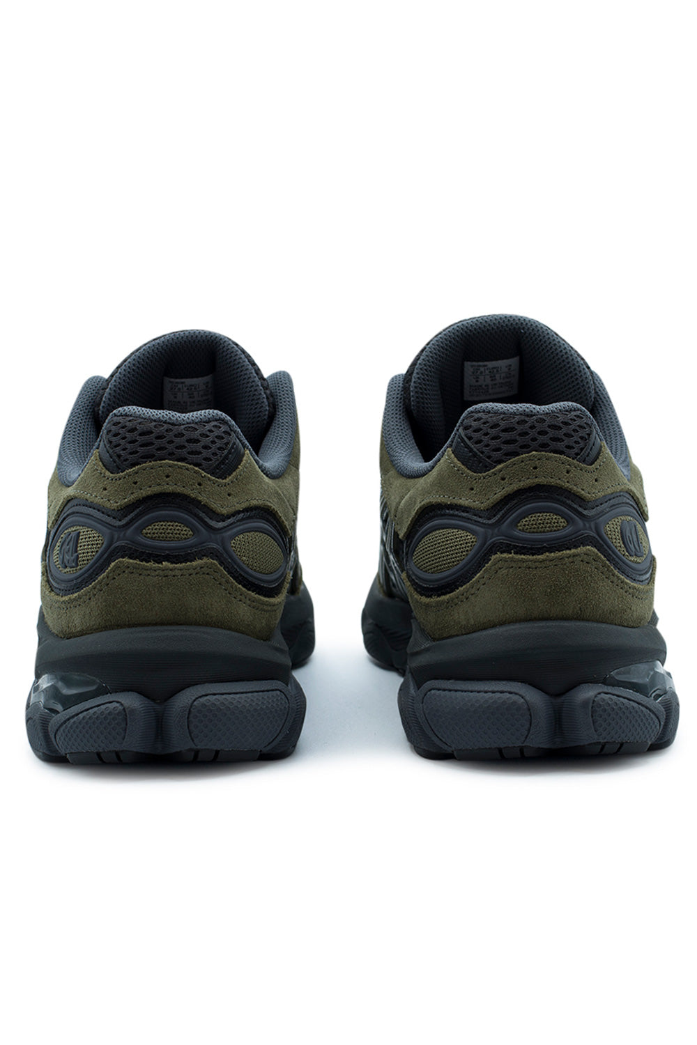 Rear studio shot of the heels of the Asics Gel-NYC 2.0 sneakers, displaying the layered loden green suede heel counter, graphite open-cell mesh collar, dark grey molded TPU heel cage overlay with debossed "GEL" branding, and black rubber outsole finish