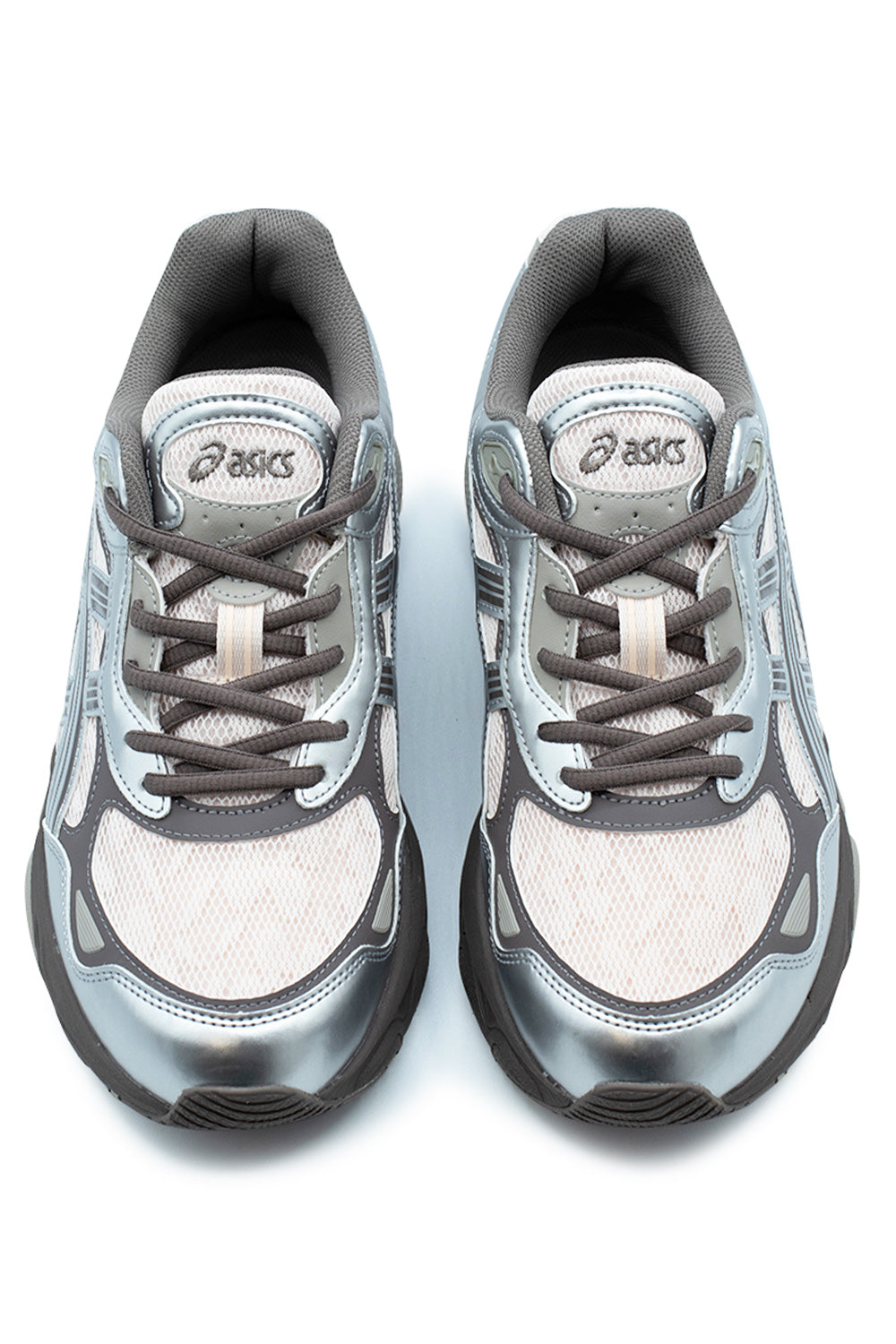 Top-down studio shot of a pair of Asics Gel-NYC 2.0 shoes in Pink Cloud / Pure Silver, displaying the coarse pink mesh toe boxes, metallic silver mudguards, round grey laces through synthetic eyelet stays, and padded mesh tongues with oval metallic Asics logo patches.
