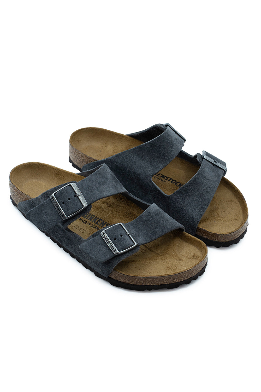Three-quarter perspective studio shot of the Birkenstock Arizona BS Charcoal sandals, showcasing the dark grey suede texture, matte color-coordinated hardware buckles, and ergonomic cork footbed structure.