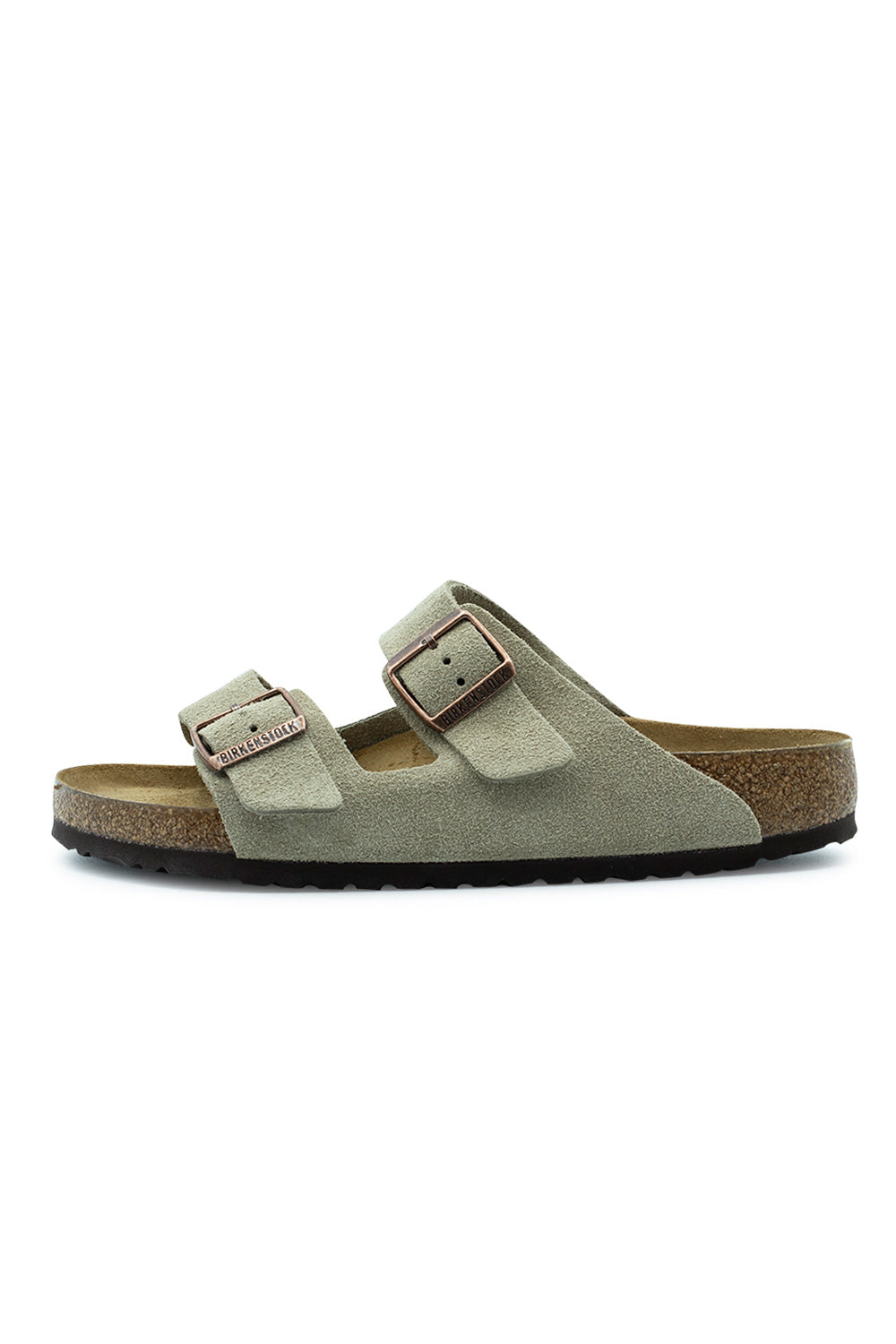 Lateral side profile view of the Birkenstock Arizona BS sandal in Taupe suede, featuring two wide adjustable suede straps with copper metal pin buckles, a natural cork-latex footbed layer, and a dark brown EVA outsole.