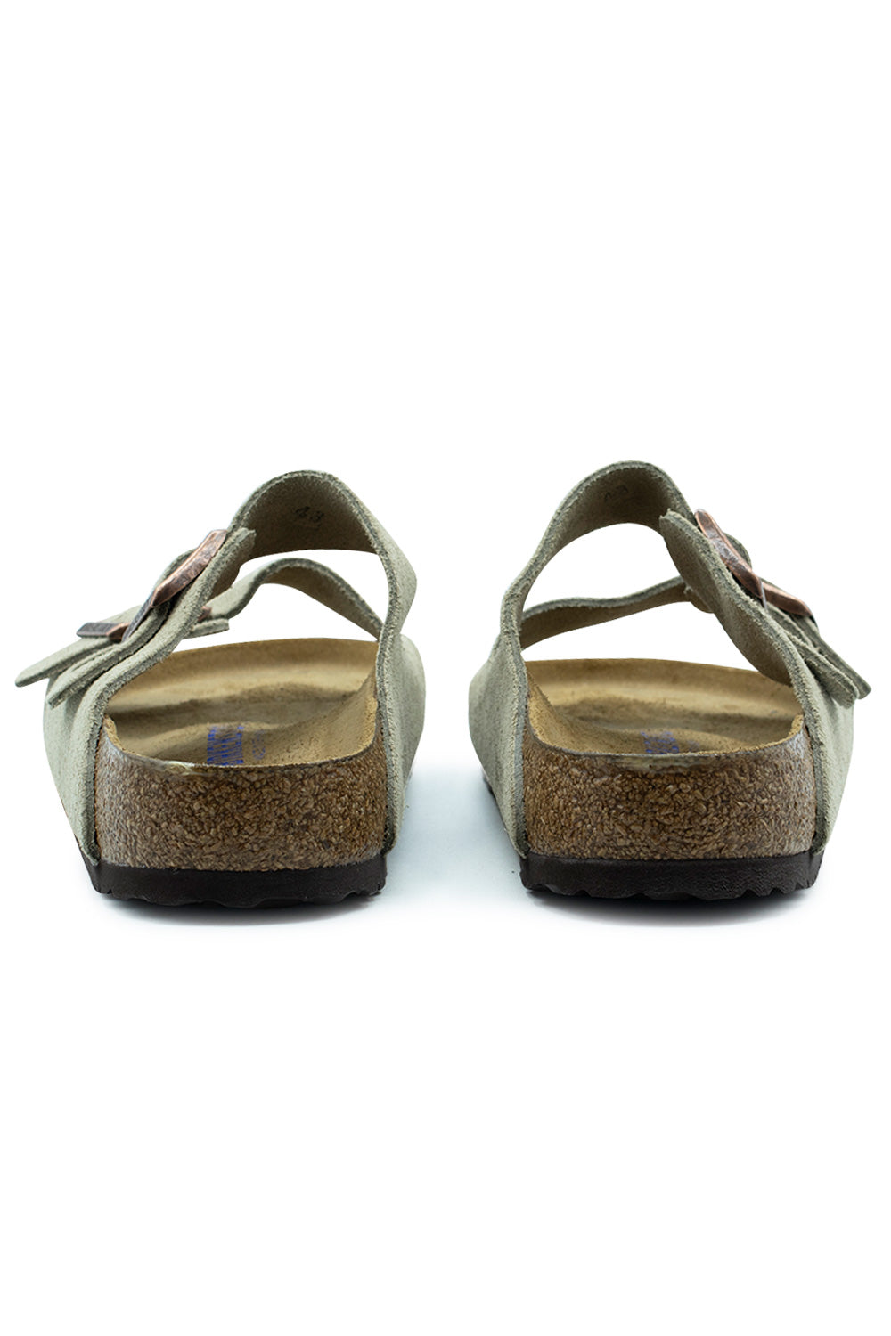 Rear view of the heels of the Birkenstock Arizona BS Taupe sandals, displaying the anatomical cork heel cups, raised side borders, dark brown EVA tread soles, and open-back mule construction.