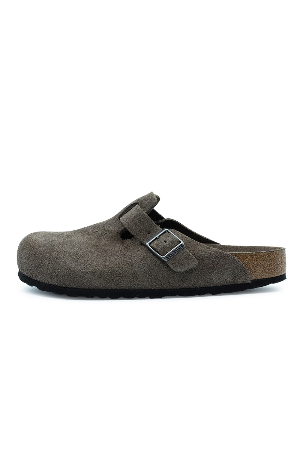 Lateral side profile view of the Birkenstock Boston BS Clog in Concrete Grey suede, displaying the smooth closed-toe upper, adjustable instep strap with a gunmetal metal pin buckle, natural cork-latex midsole layer, and black EVA outsole.