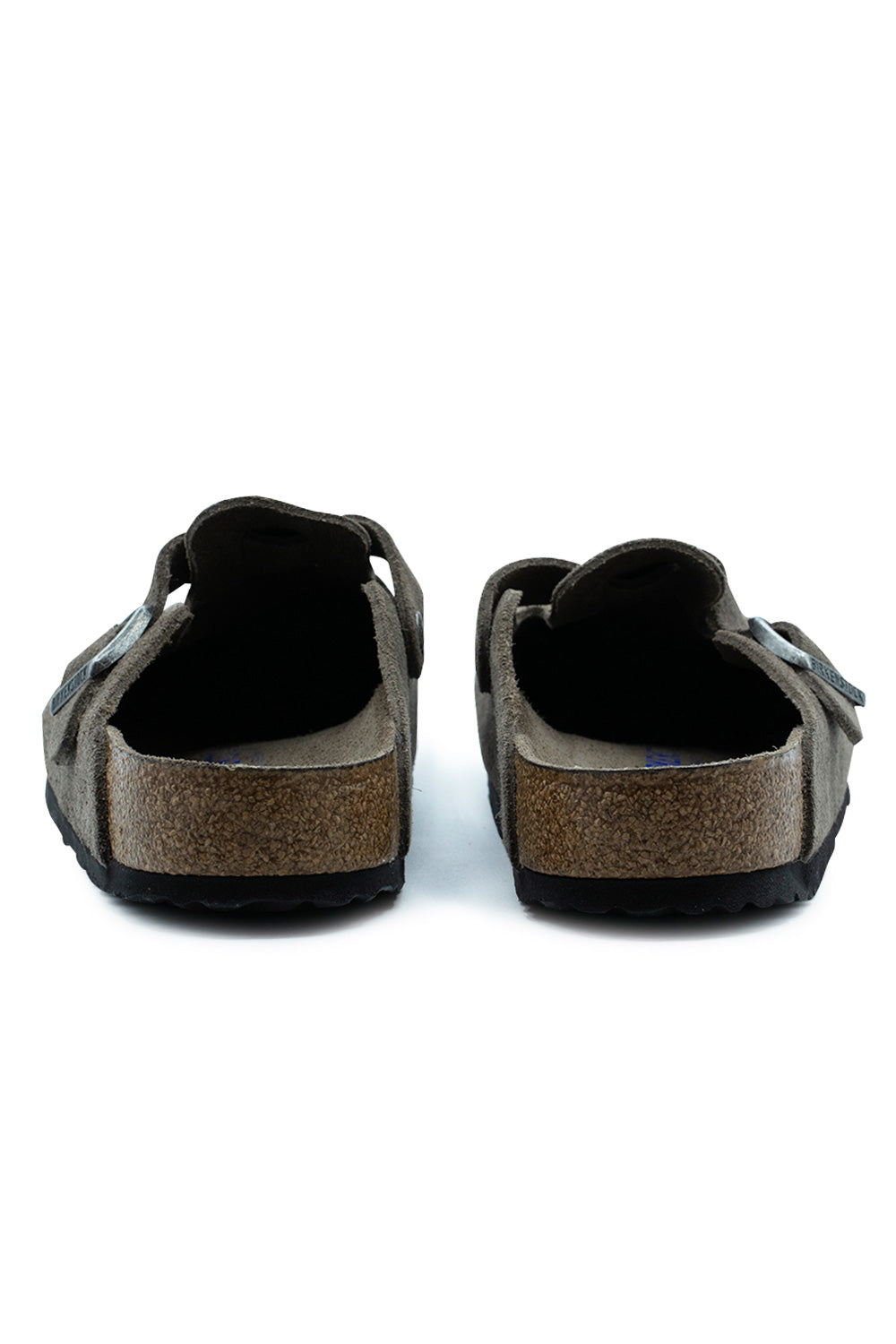 Rear view of the open heels of the Birkenstock Boston BS Concrete Grey suede clogs, featuring the ergonomic cork heel cup construction and black treaded EVA sole layer.