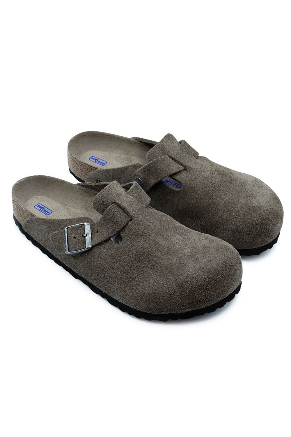 Three-quarter perspective studio shot of the Birkenstock Boston BS Clogs in Concrete Grey suede, showcasing the classic slip-on silhouette, metallic hardware, and contoured cork footbed.