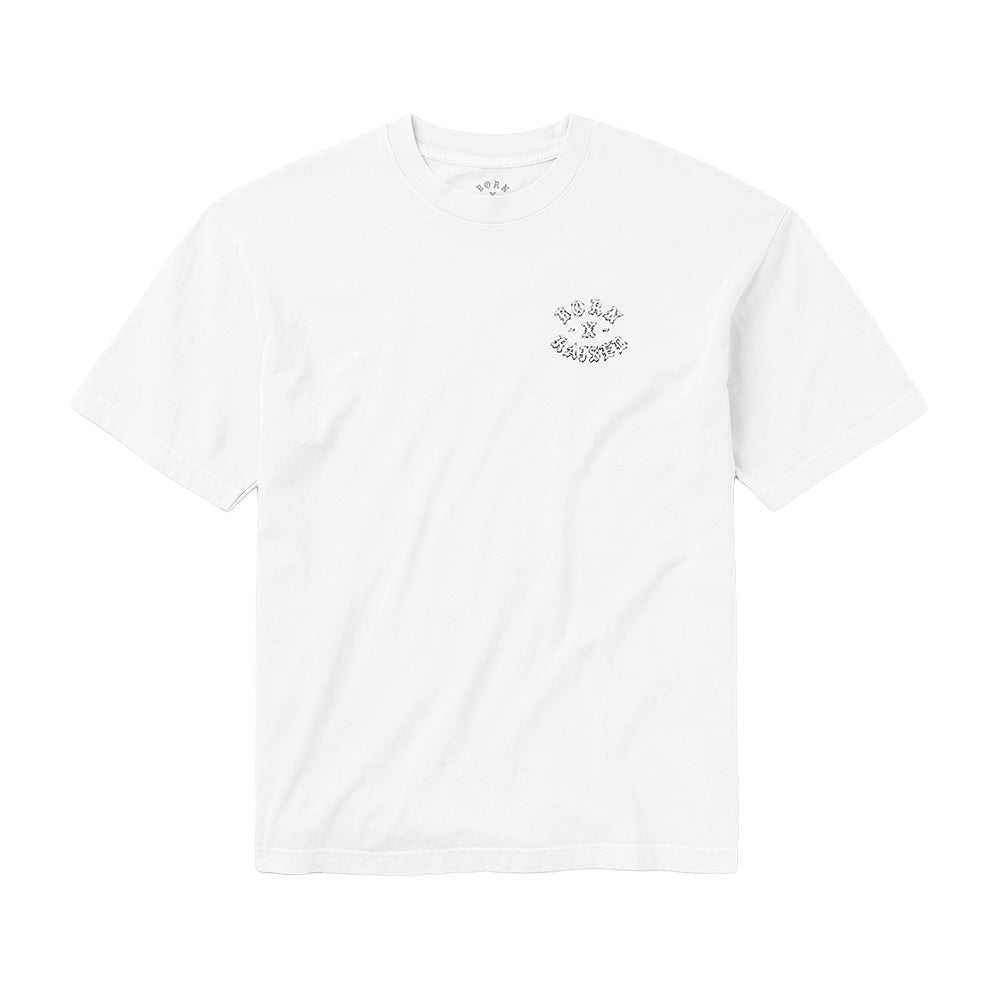 Front flat lay studio perspective of the white Born X Raised Fantasy Rocker T-Shirt, featuring a ribbed crewneck collar with interior printed branding, short sleeves, and a minimalist circular screen print of the arched Old English "BORN X RAISED" rocker logo positioned cleanly on the left chest.