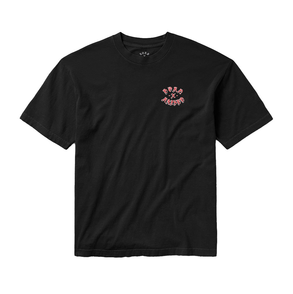 Front flat lay studio perspective of the black Born X Raised Gothic Rocker T-Shirt, displaying a ribbed crewneck collar with printed interior neck details, spacious short sleeves, and a miniature circular chest print of the red Gothic "BORN - X - RAISED" rocker calligraphy positioned on the left breast.