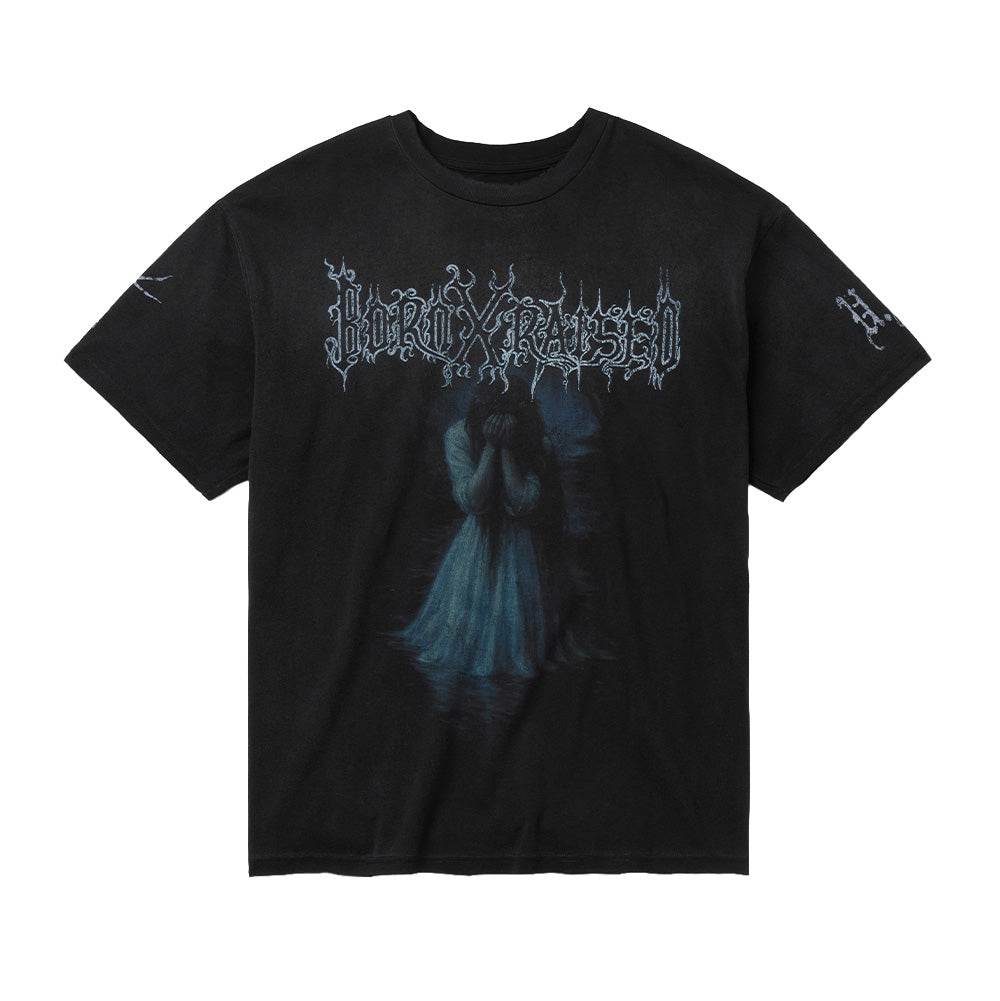 Front flat lay studio view of the Born X Raised Llorona T-Shirt in washed vintage black, showcasing a relaxed heavyweight streetwear silhouette with a distressed ribbed crewneck collar, centered by a large graphic print featuring the weeping folklore ghost La Llorona submerged in water, topped with an icy white black-metal-style thorny "BORN X RAISED" logo, complemented by sleeve screen prints.