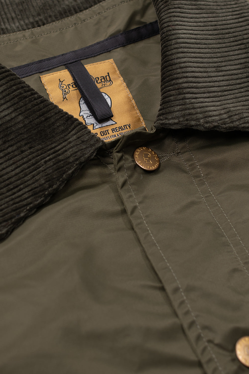 Brain Dead Cropped Chore Jacket Green, premium wide-fit nylon jacket featuring corduroy inner lining and gold Brain Dead branded hardware.