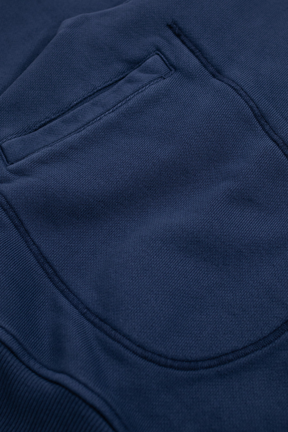 Detailed view of Brain Dead Half Zip Collared Sweatshirt Midnight showing curved front pocket design and heavyweight cotton french terry fabric on modern boxy streetwear pullover