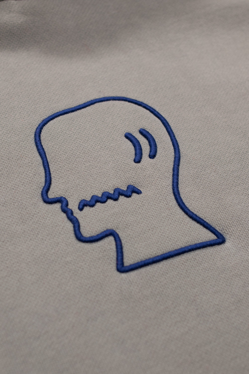 Brain Dead Mendoza Cropped Hoodie Cement, relaxed streetwear pullover featuring wide hood, heavy fabric, and dark blue embroidery.