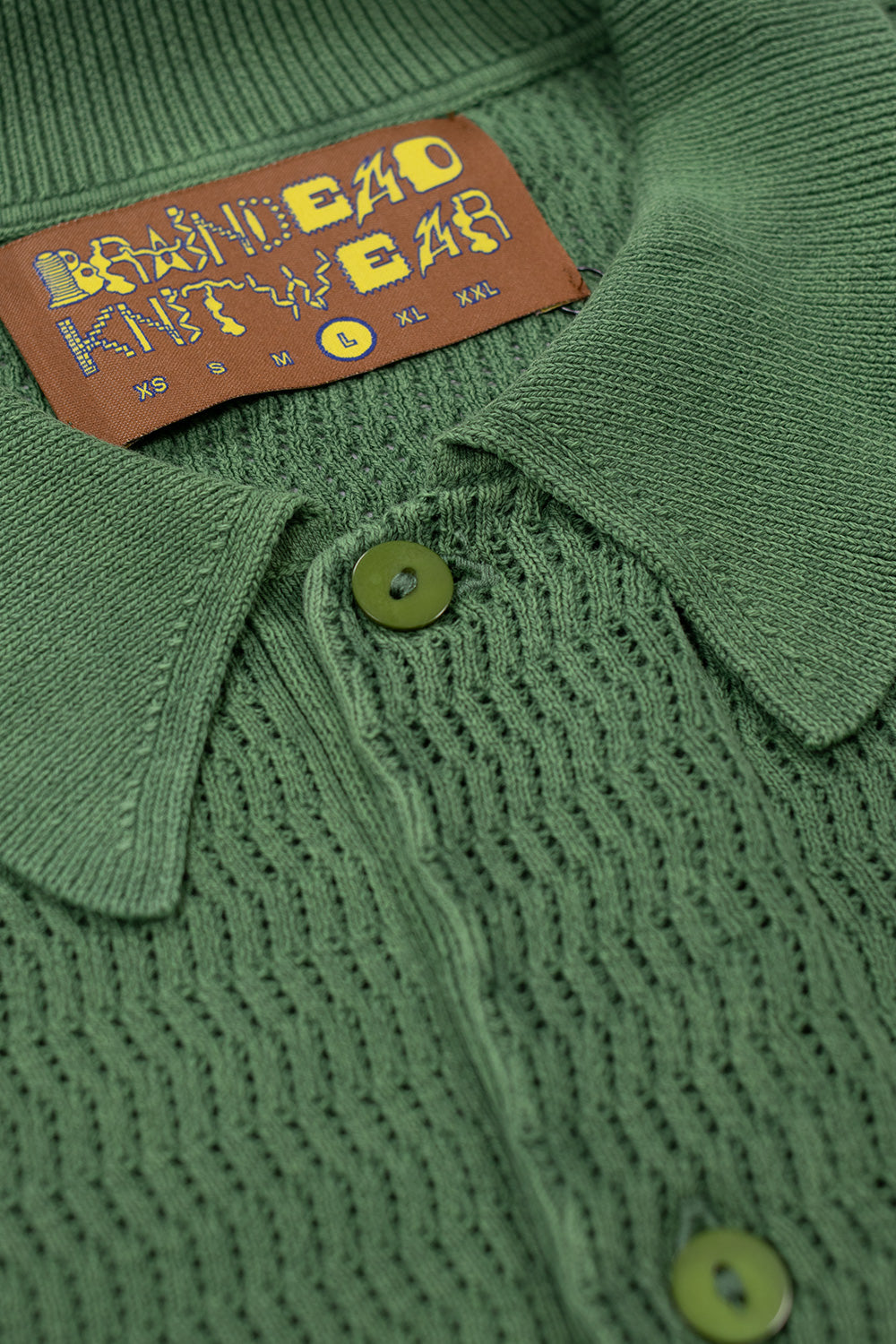 Brain Dead Pigment Dye Long Sleeve Polo Sweater Green collar detail – textured knit polo collar with button placket and Brain Dead woven label