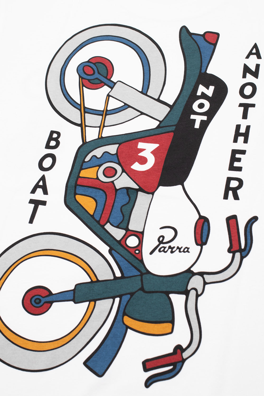 Macro close-up shot of the back graphic print on the white By Parra Not Another Boat T-Shirt, detailing the clean water-based color fills in red, blue, and yellow forming the mechanical parts, spoked wheels, racing number 3, and bold "NOT ANOTHER BOAT" lettering.
