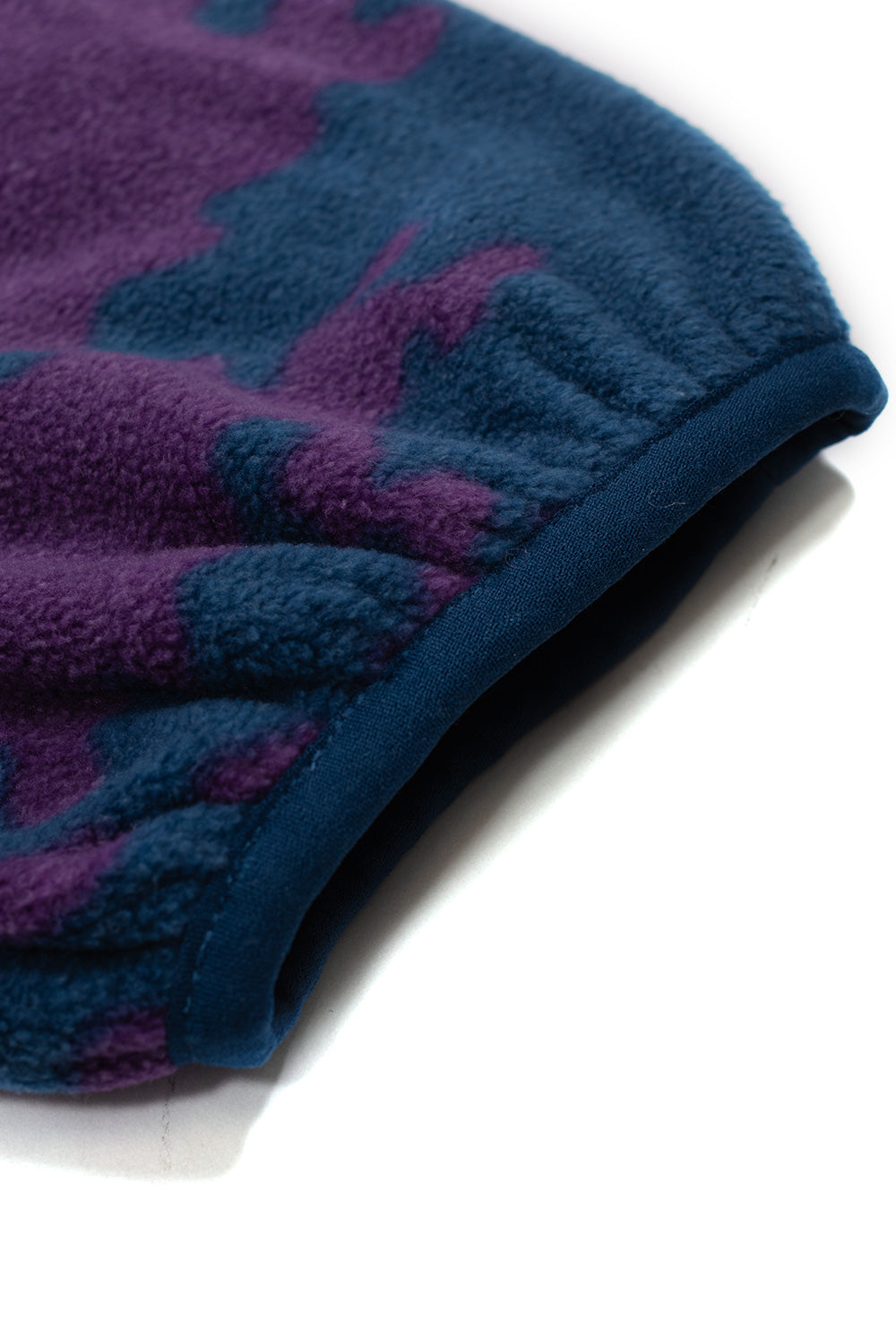 Extreme close-up shot of the elasticated sleeve cuff on the By Parra fleece jacket, detailing the soft sheared texture of the purple and blue camouflage polyester fleece and the gathered stretch binding trim.