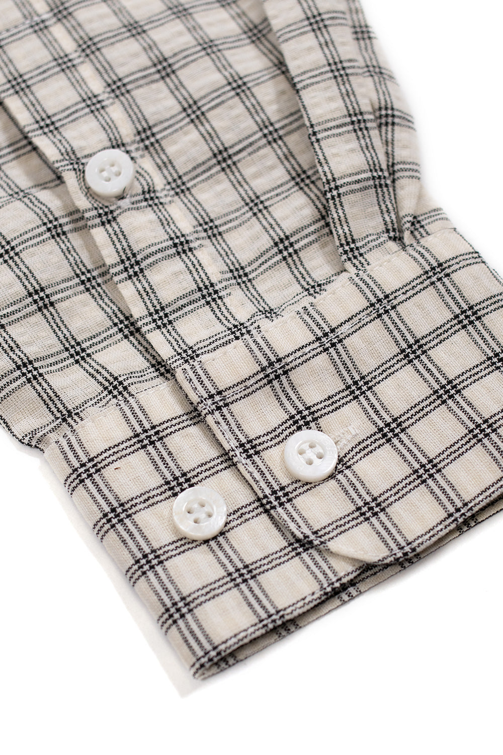 Detail view of the black butterfly logo patch stitched onto the chest pocket of the Bye Jeremy Supper Button Up Shirt with summit white checkered cotton fabric.