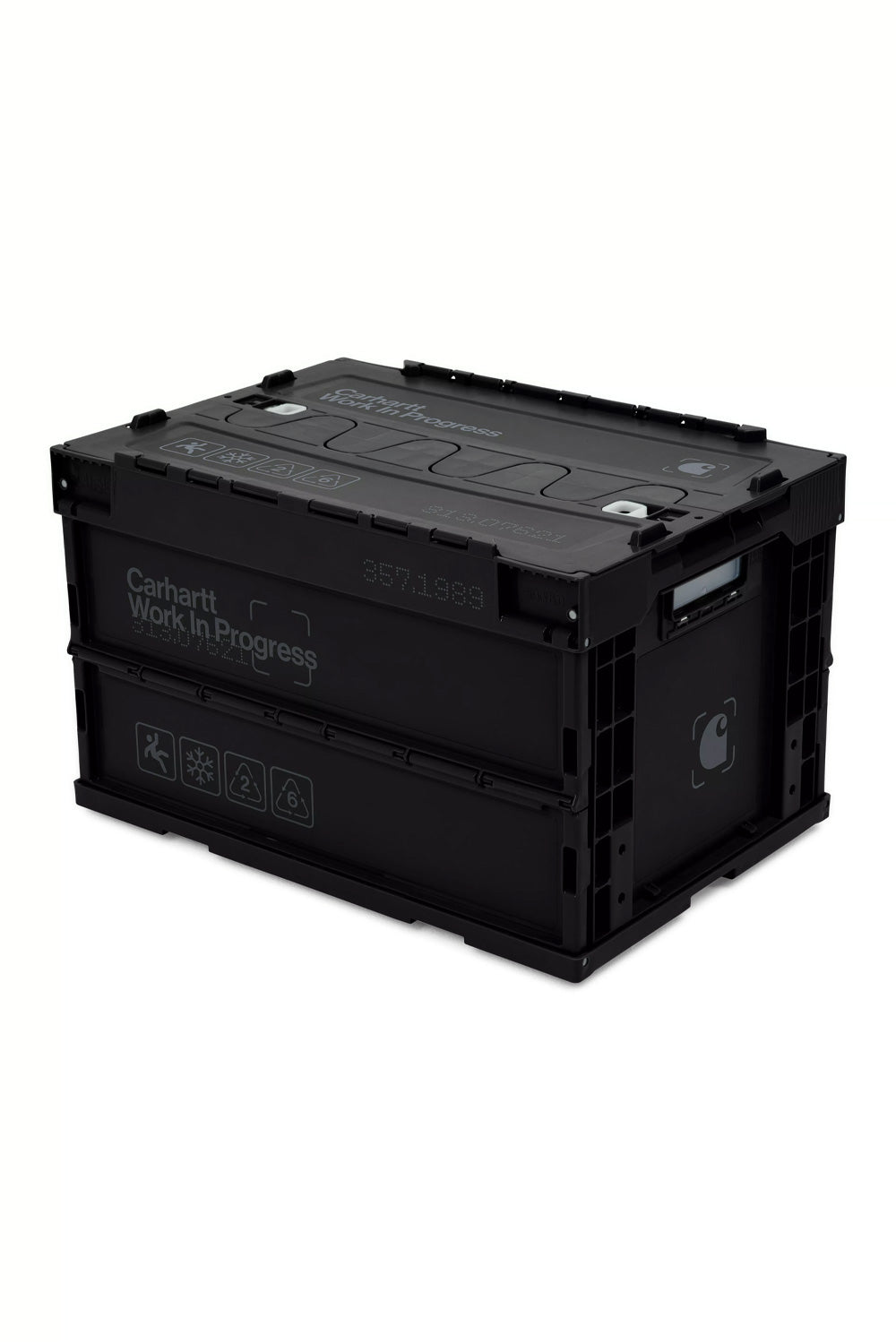 High-angle studio shot of the fully assembled Carhartt WIP Boxed Foldable Container in black and dark grey, featuring a 50-liter capacity, reinforced ribbed plastic frame, split-folding interlocked lid, side carry handles, printed Carhartt Work In Progress typography, and industrial icon graphics.