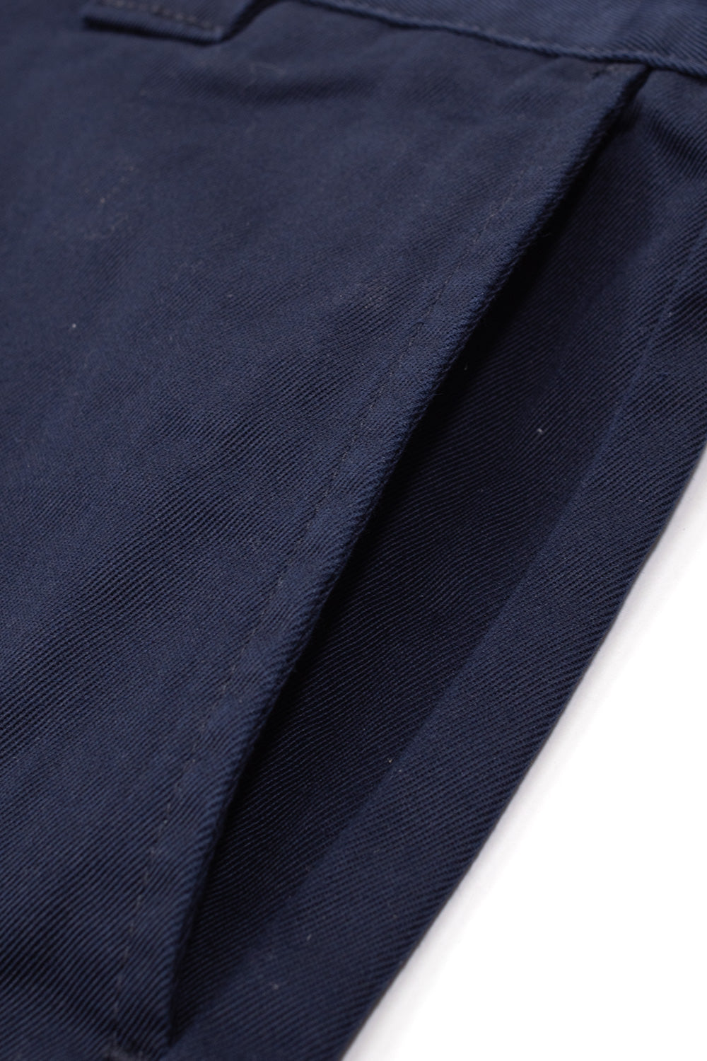 Close-up angle of the front side slash pocket opening on the dark navy Carhartt WIP OG Master Pant, displaying the durable diagonal twill weave texture, tonal bartack reinforcement, and heavyweight poly-cotton blend construction.