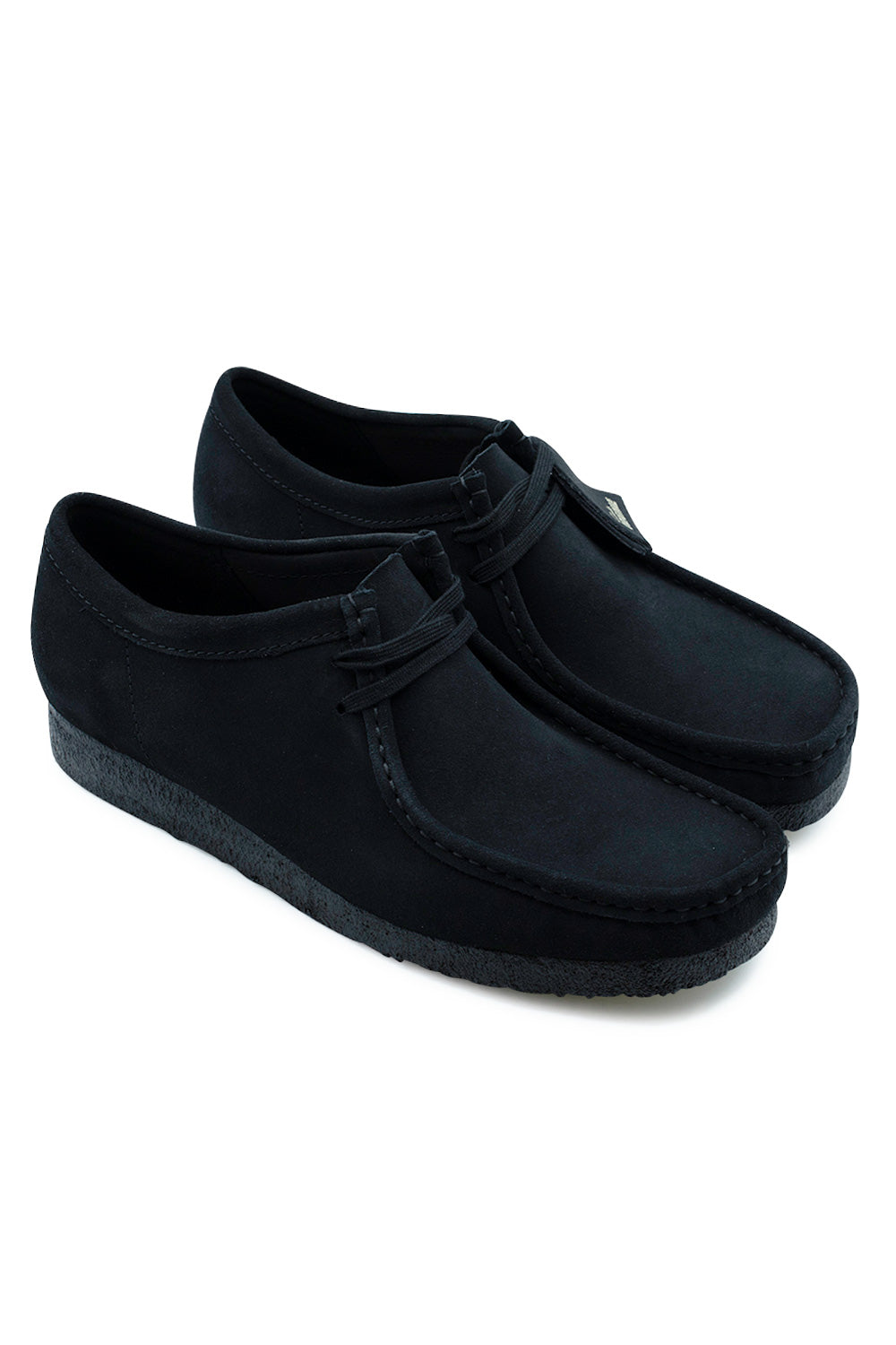 Three-quarter perspective studio shot of the Clarks Originals Wallabee shoes in Black Suede, showcasing the timeless low-profile moccasin silhouette, rich black suede texture, and matching black crepe sole unit.