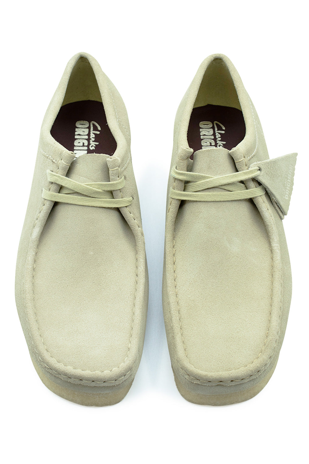 Top-down view of a pair of Clarks Originals Wallabee shoes in Maple Suede, highlighting the square toe box design, tonal waxed cotton laces, clean moccasin seam stitching, and brown leather insoles printed with white Clarks Originals branding.
