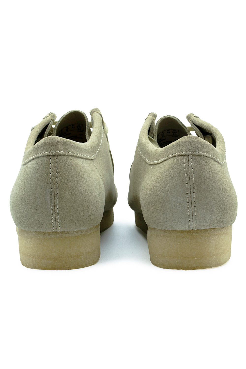 Rear view of the heels of the Clarks Originals Wallabee Maple Suede shoes, displaying the smooth beige suede heel counters with central vertical contrast stitching and the thick semi-translucent natural crepe rubber heel.