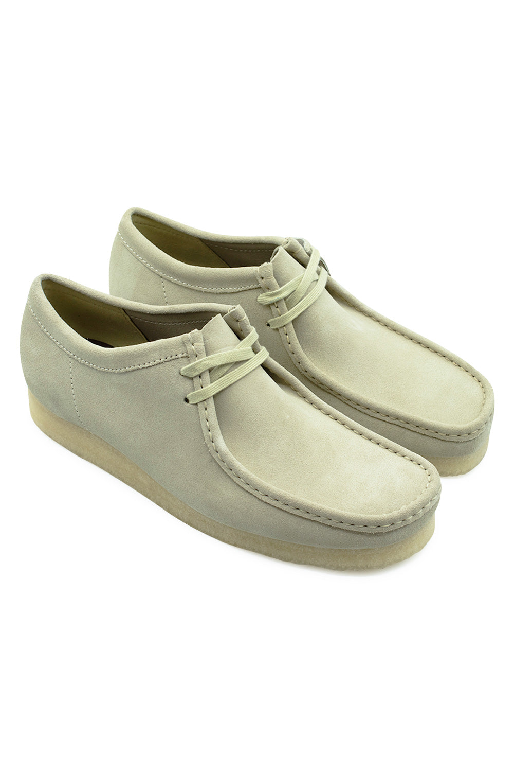 Three-quarter perspective studio shot of the Clarks Originals Wallabee shoes in Maple Suede, demonstrating the low-top silhouette, apron toe construction, and iconic natural crepe sole build.