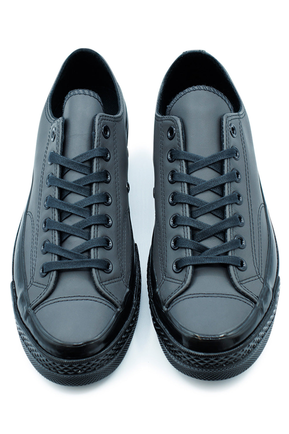 Converse Chuck 70 OX Black Dark Matter Black low-top shoes, durable leather construction with retro All Star license plate heel detail.