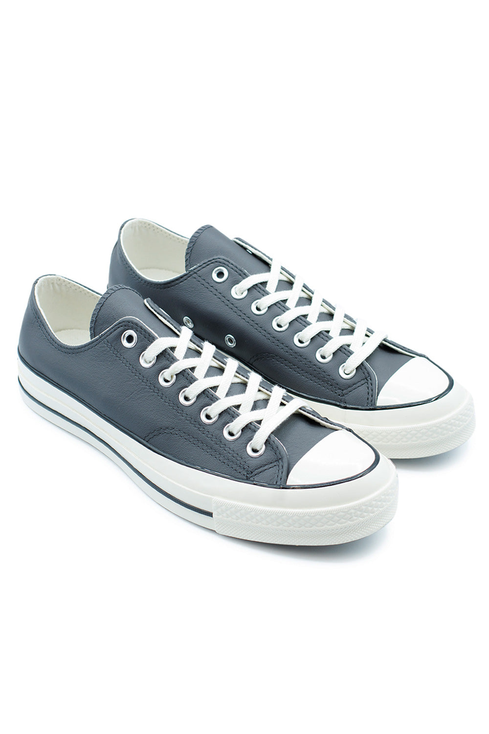 Side view of Converse Chuck 70 OX Dark Matter Egret, vintage-inspired sneaker with white midsole, detailed stitching, and retro license plate.