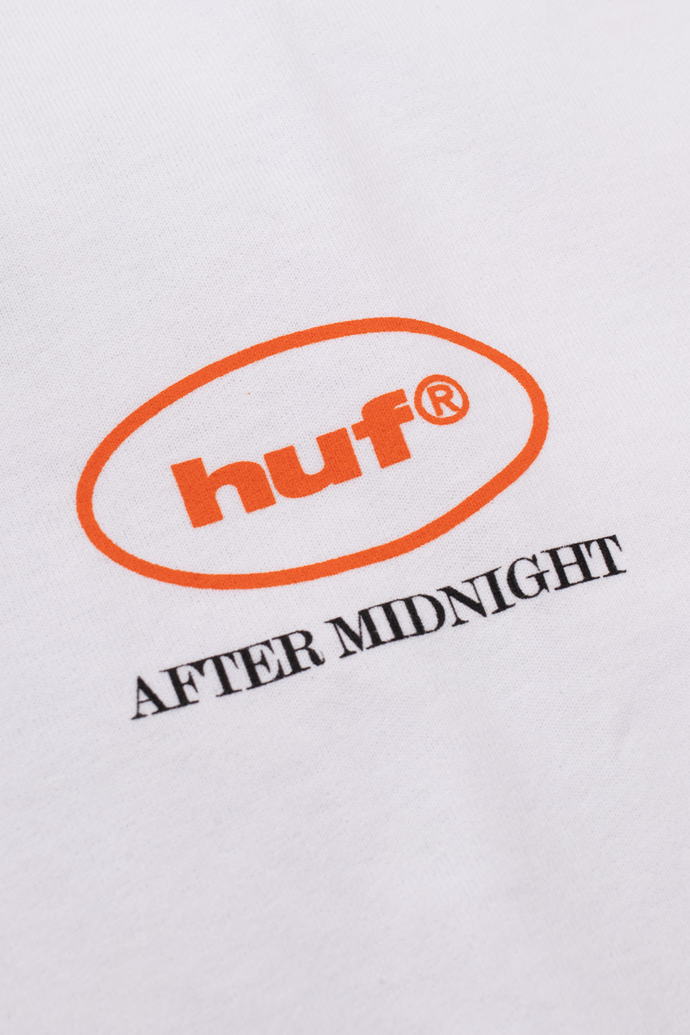 Close-up of the HUF After Midnight chest logo printed on a white heavyweight cotton T-shirt, featuring clean branding and premium finish