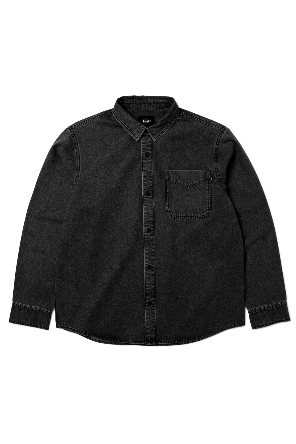 Front flat lay view of the HUF Carson Overdyed Denim Long Sleeve Shirt in washed black, made from 235g 100% cotton denim, featuring a point collar, full tonal black button-down front placket, rounded hem, long sleeves with button cuffs, and an open left-chest patch pocket with a black HUF woven logo flag label