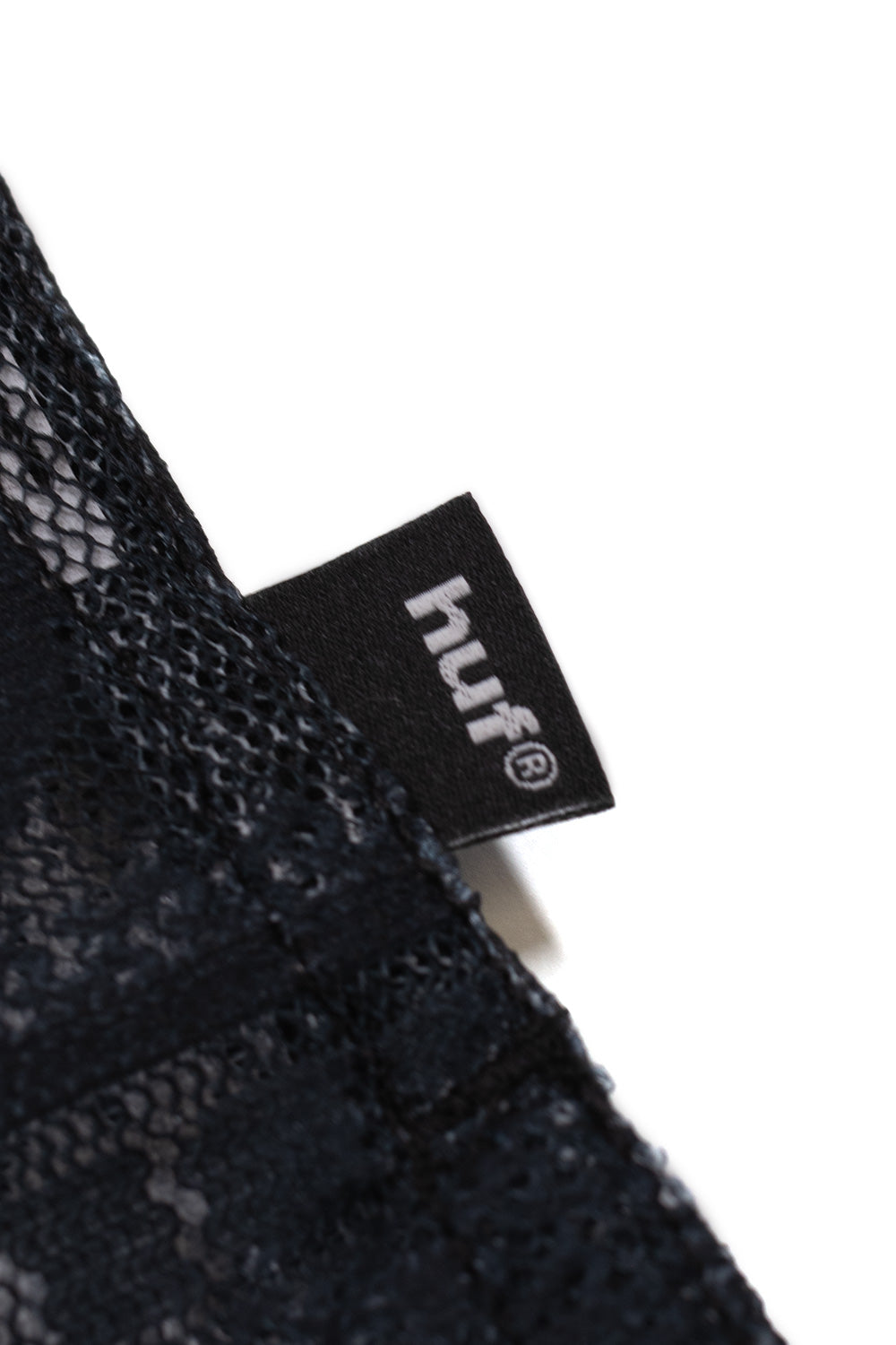 HUF logo flag label on the Global Currency S/S Lace Shirt Black featuring premium woven branding and breathable lace fabric construction