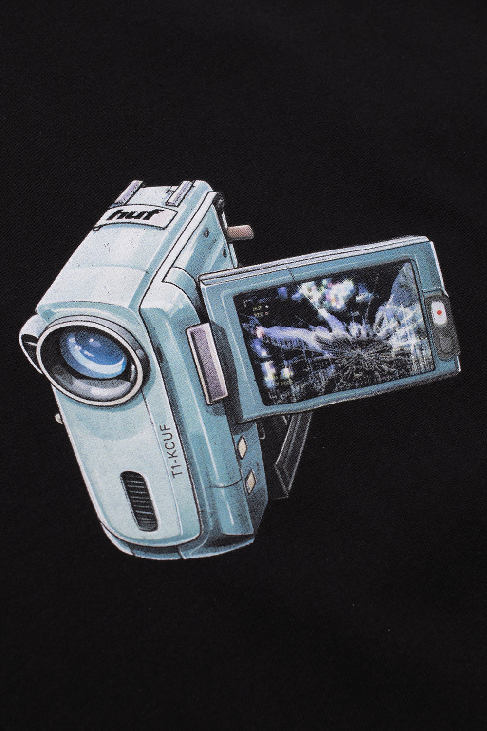 Close-up of the HUF H Cam T-Shirt chest print featuring a retro handheld camcorder illustration and digital recording inspired artwork