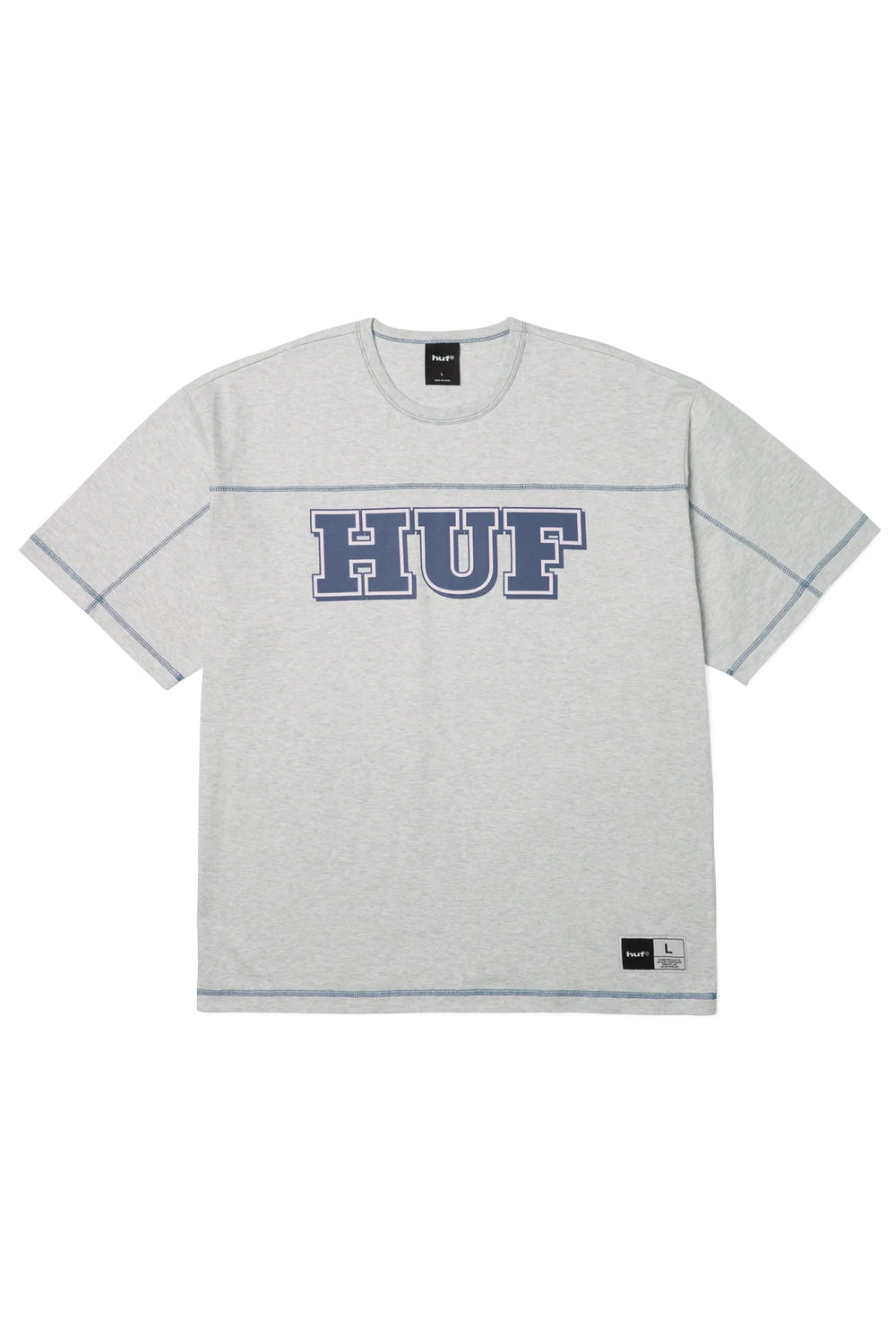 Front view of the heather grey HUF Legacy Football T-Shirt, crafted from heavy 240g 100% cotton jersey in an oversized boxy silhouette, showcasing a large navy blue collegiate HUF chest print with white outlines, dark blue contrast flatlock stitching along the horizontal yoke and sleeves, and a woven locker patch on the lower left hem.