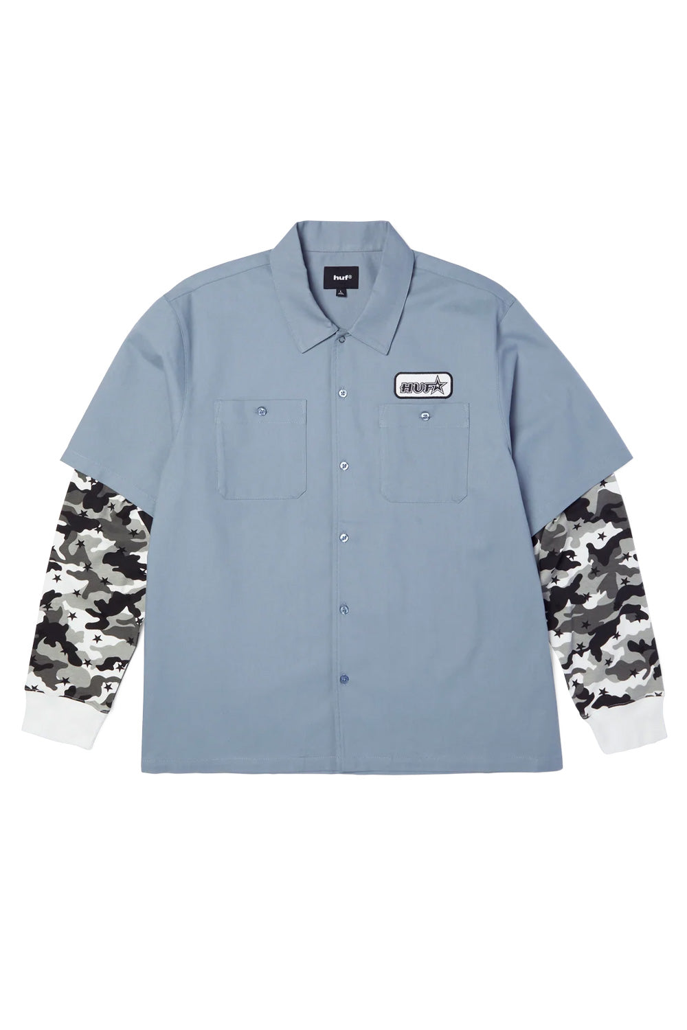 Front flat lay view of the HUF Shadows Long Sleeve Work Shirt in light blue, featuring a cotton-viscose blend short-sleeve work shirt body with spread collar, full button-front closure, two buttoned chest flap pockets, a black-and-white embroidered HUF star patch on the left chest, and contrast sewn-in long sleeves in grey and white star-camo with white ribbed knit cuffs