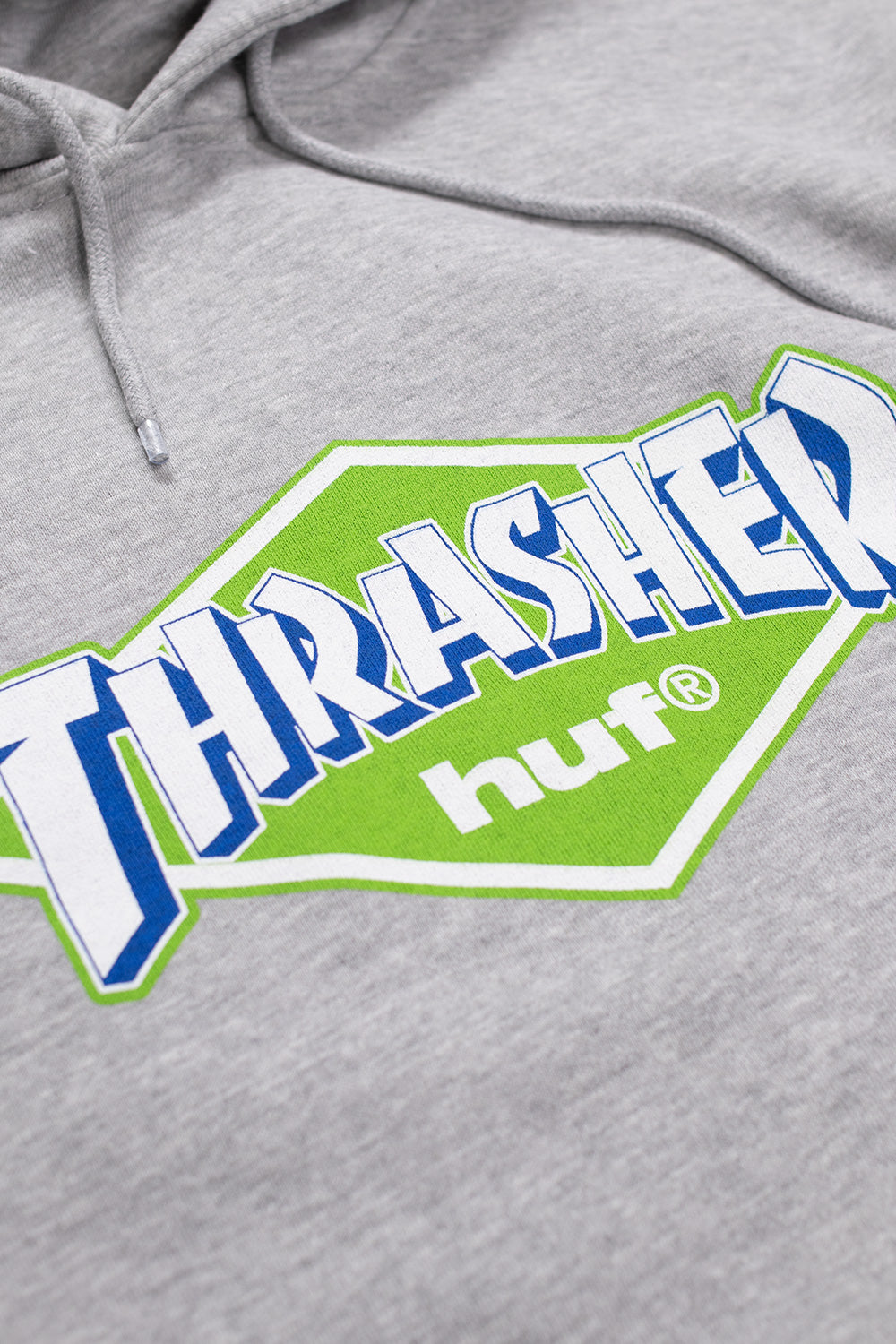 Heather Grey HUF Thrasher capsule collection hoodie featuring bold retro logos, adjustable hood, and front kangaroo pocket.