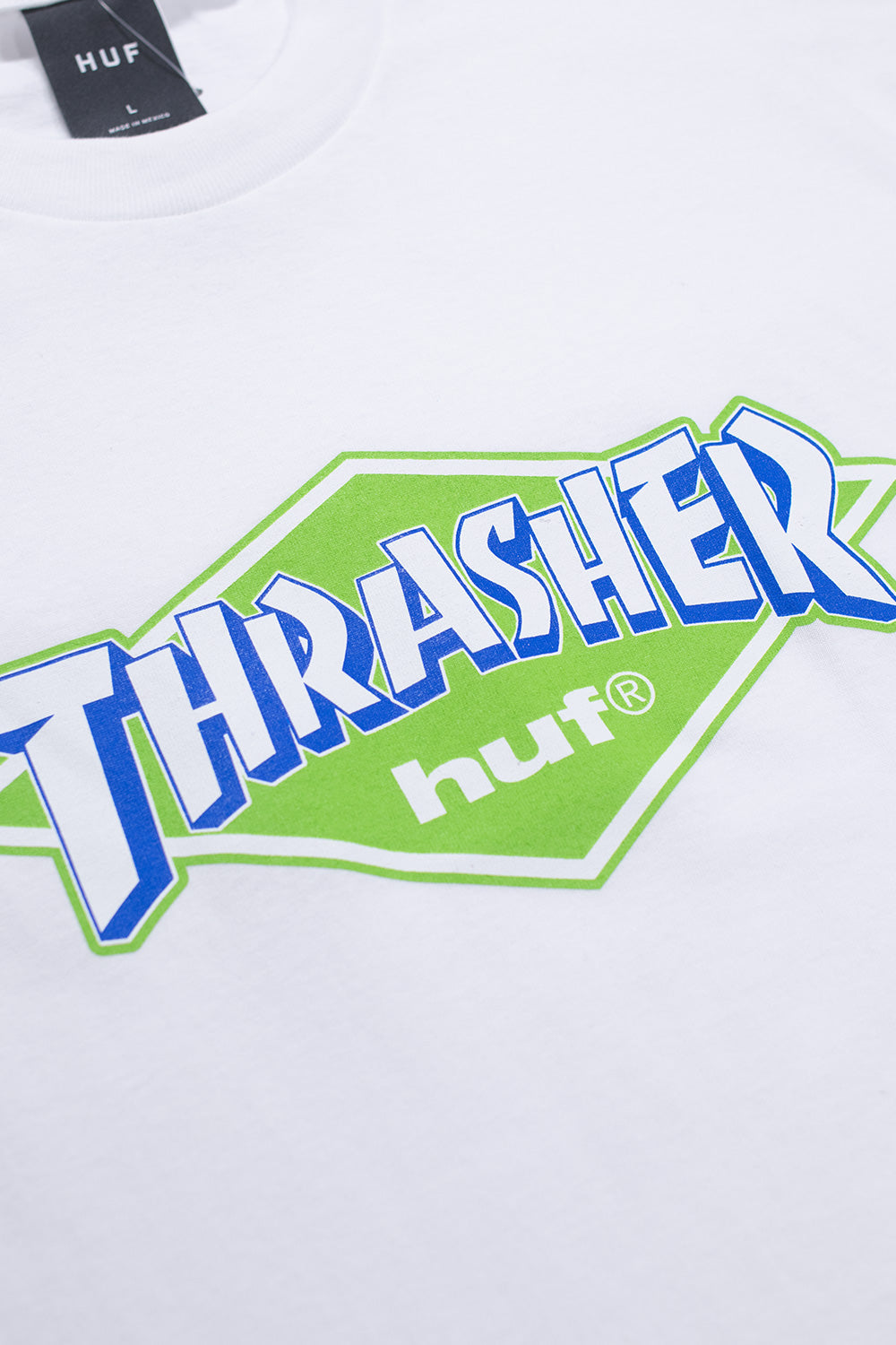Unisex HUF x Thrasher White Logo Tee, minimalist skate collaboration T-shirt with vintage print and clean streetwear aesthetic.