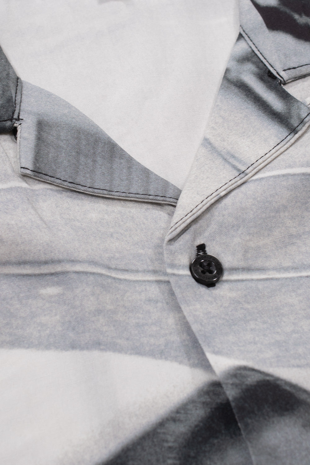 Close-up of the HUF x Dennis McGrath Burnside Resort Shirt collar featuring premium rayon fabric, classic camp collar construction and printed photographic artwork